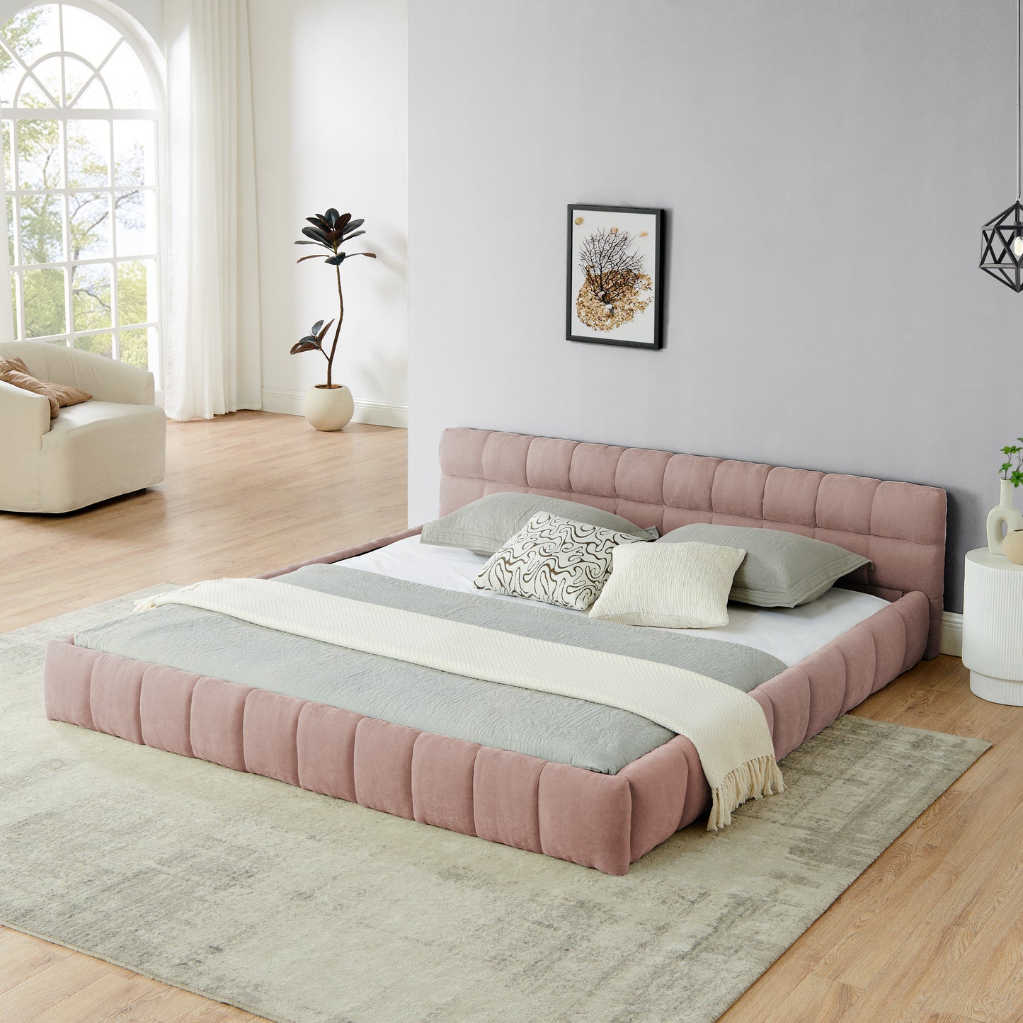 Pink chenille king bed frame with low channel-tufted headboard in a bright bedroom
