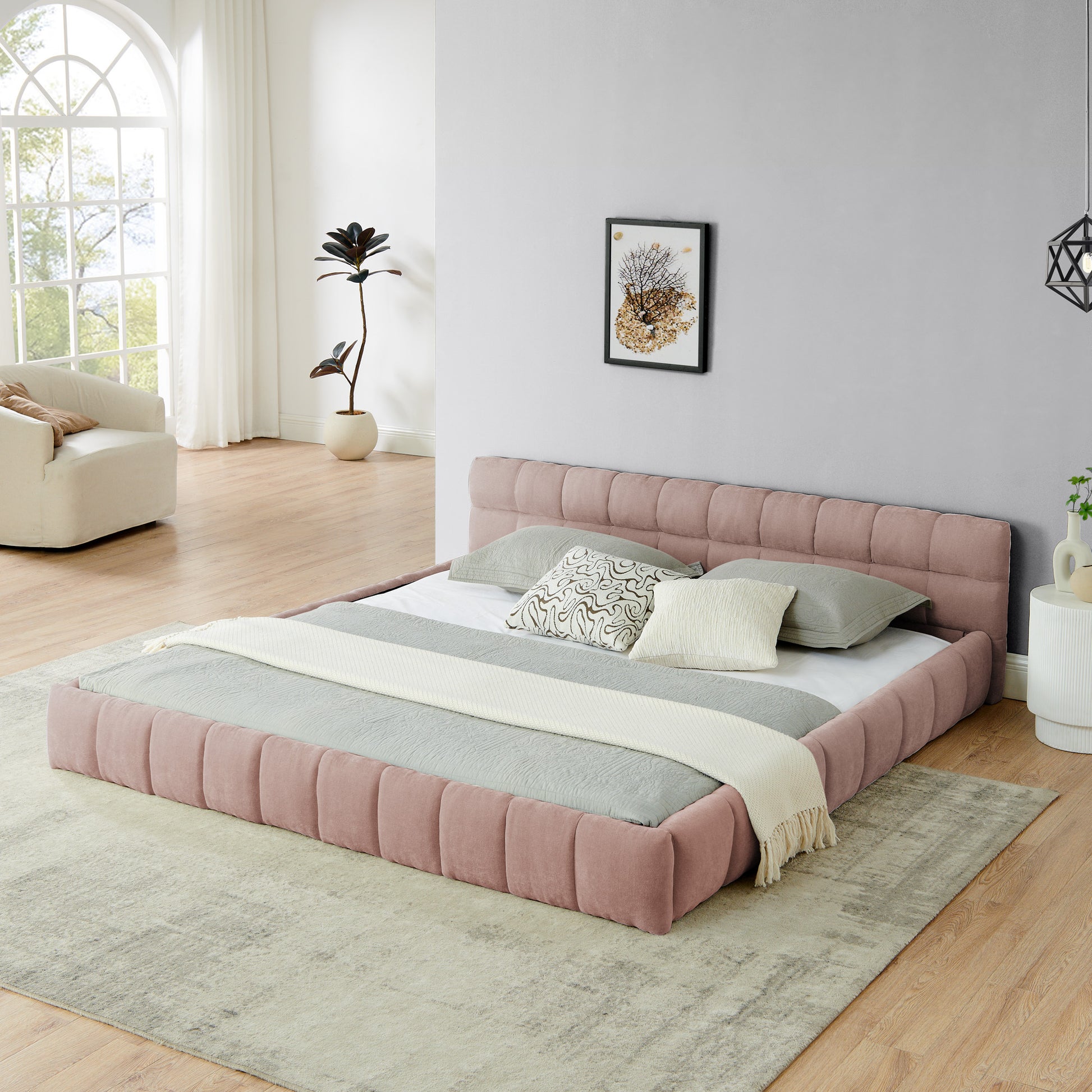 Pink chenille king bed frame with low channel-tufted headboard in a bright bedroom