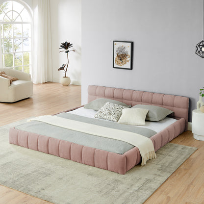 Pink chenille king bed frame with low channel-tufted headboard in a bright bedroom