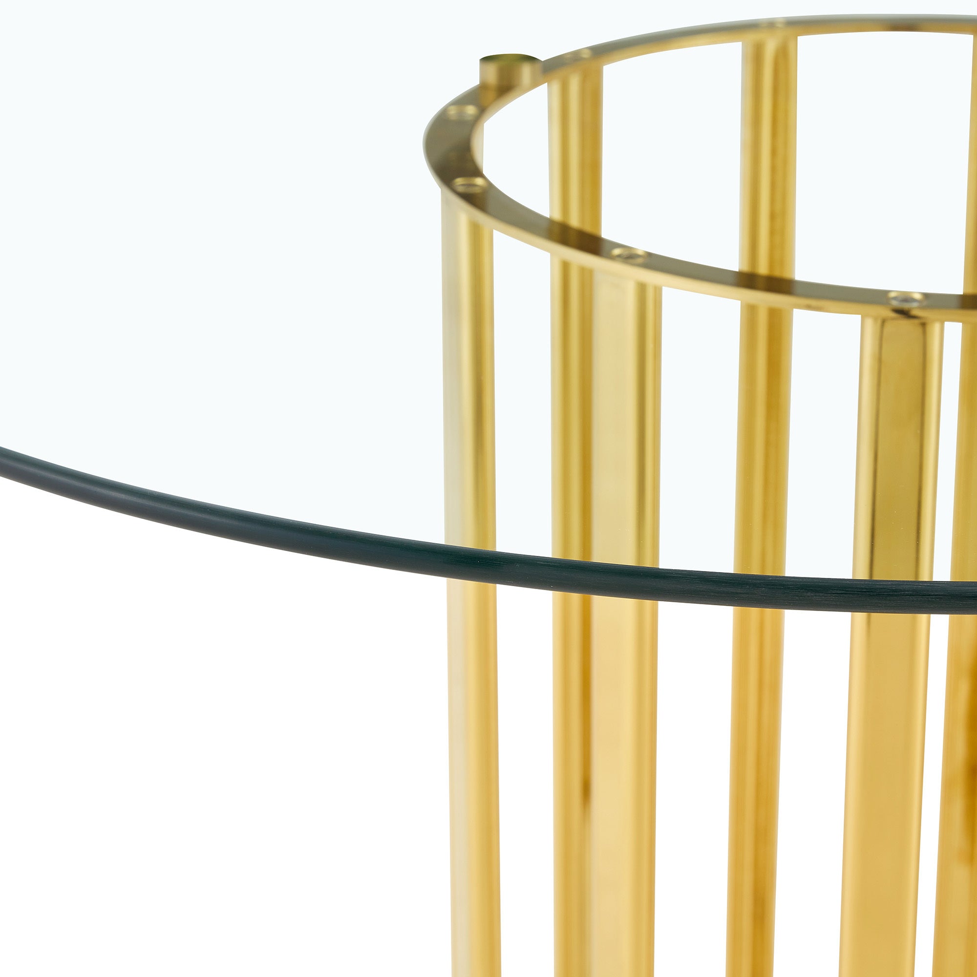 Close-up of one gold column base meeting the clear glass tabletop edge on white