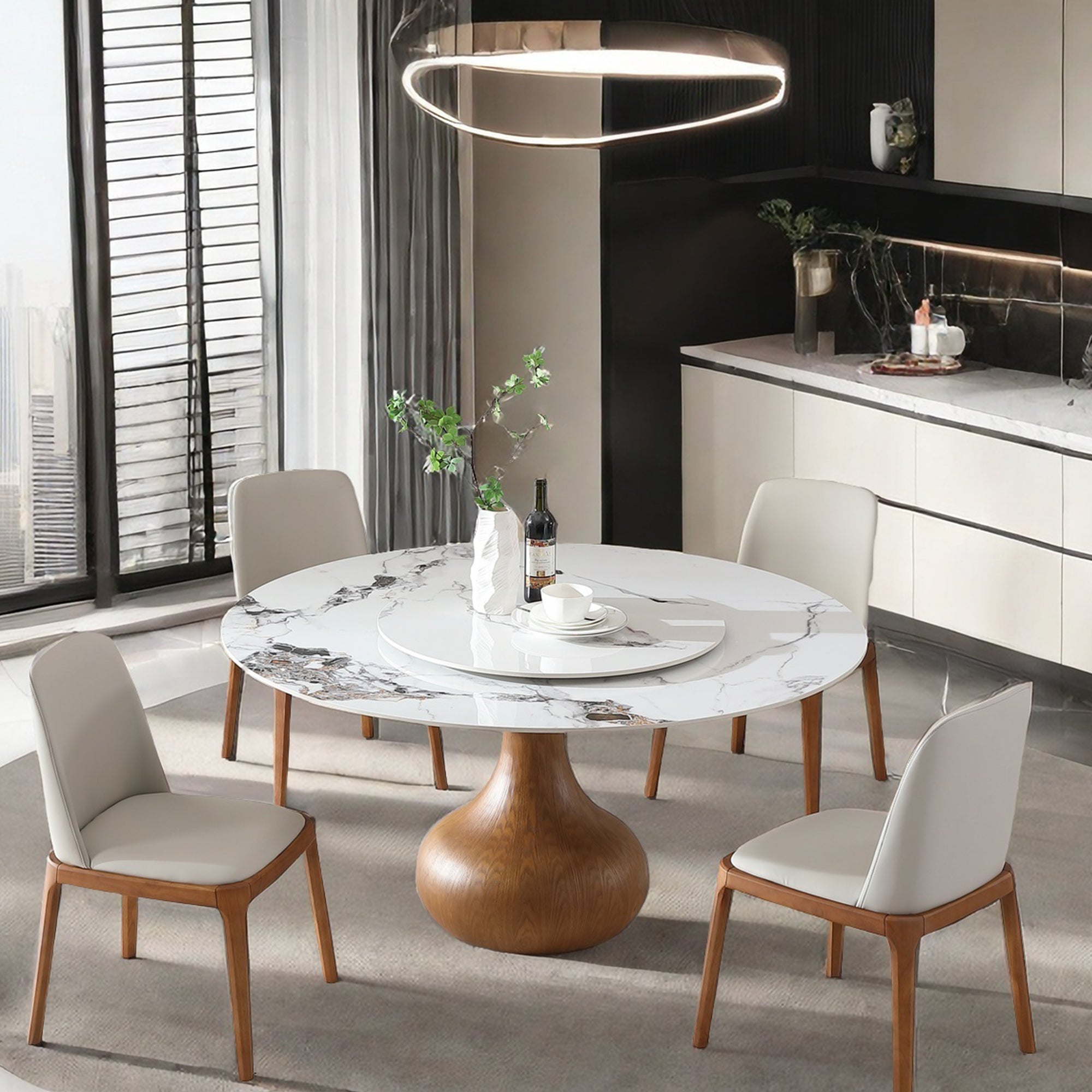 White sintered stone round dining table set with four chairs under a ring pendant, angled room view