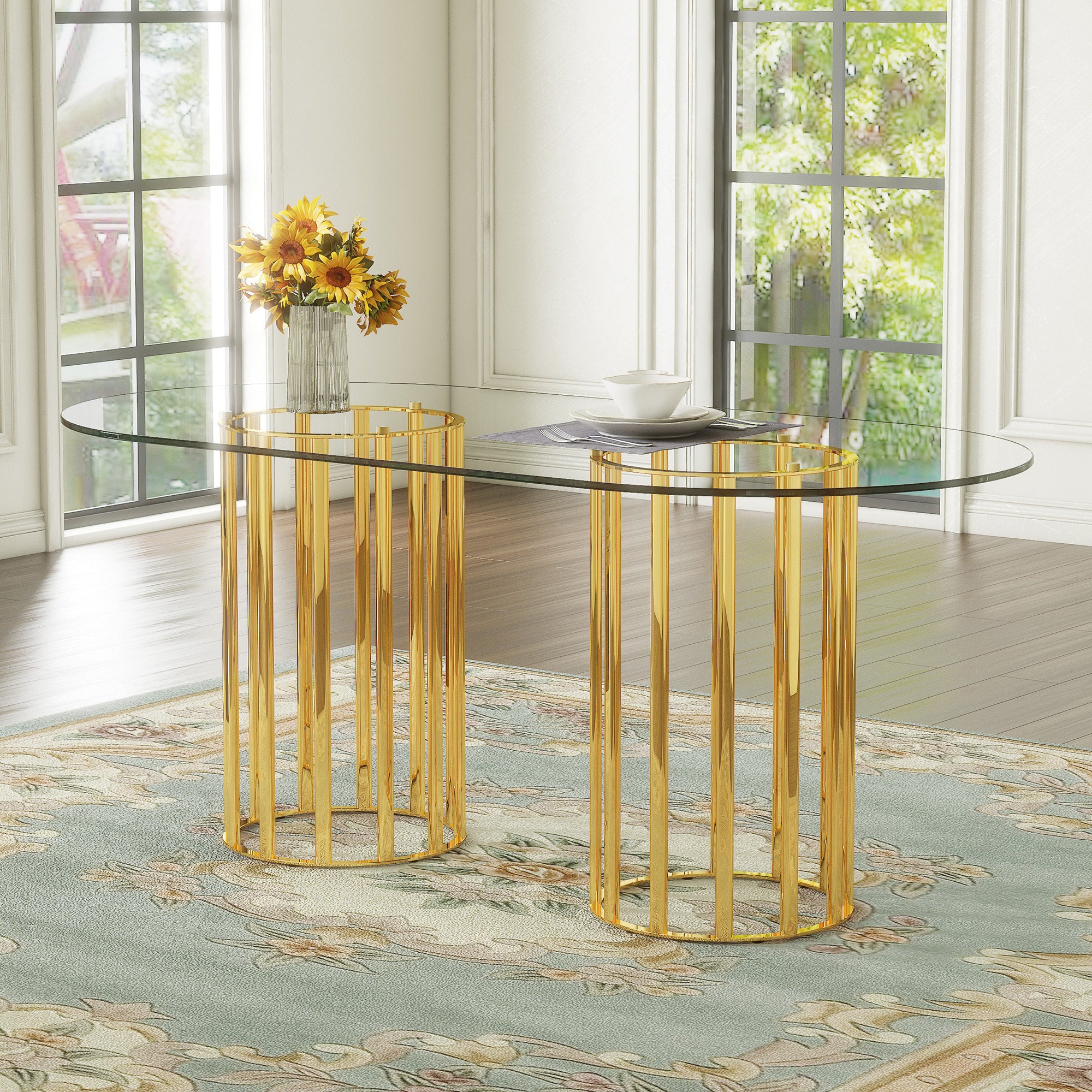 Angled side view of oval glass dining table with gold double-column base in a sunlit dining room