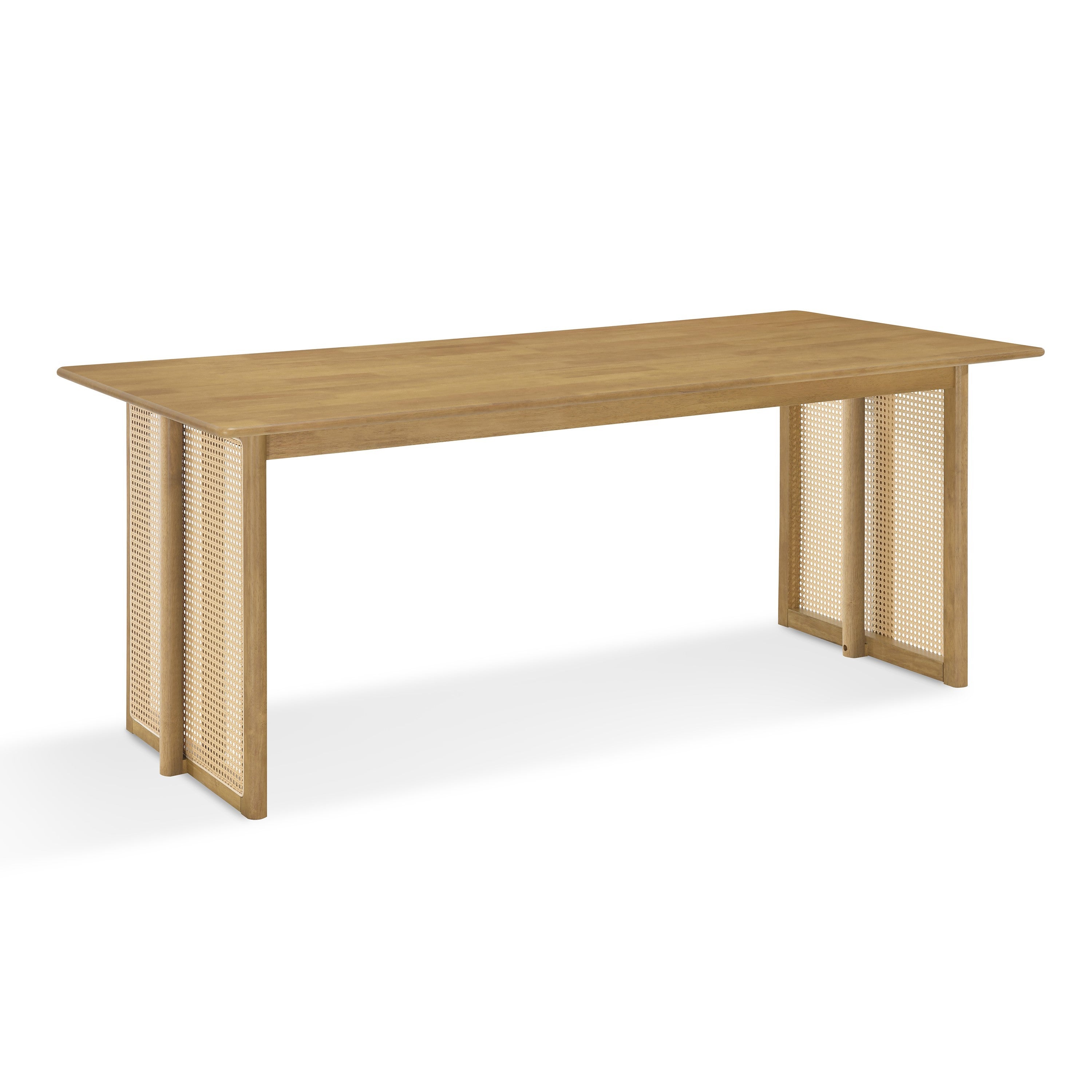 Three-quarter studio view of the natural rubberwood dining table with woven cane panel legs, white background