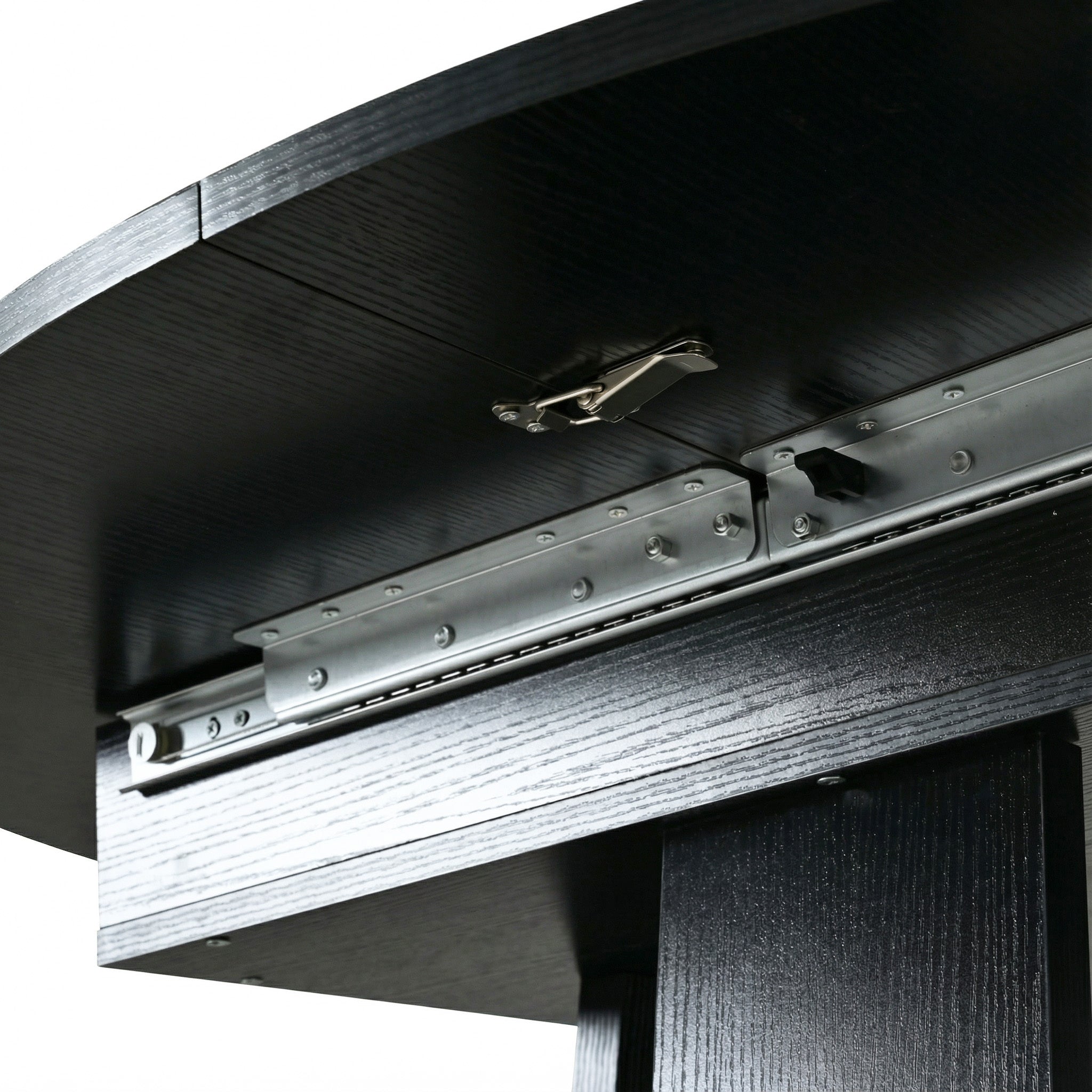 Close-up of the metal slide rails and lock latch under the black tabletop