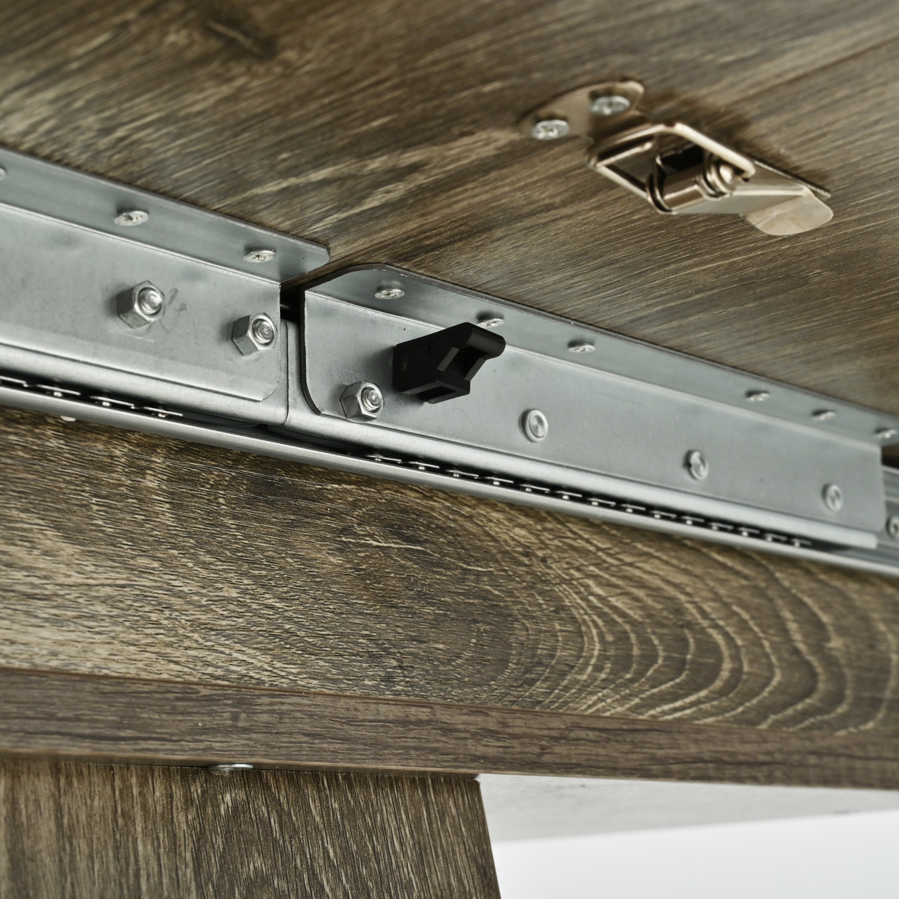 Close-up of the slide-rail extension mechanism with black stopper and toggle latch