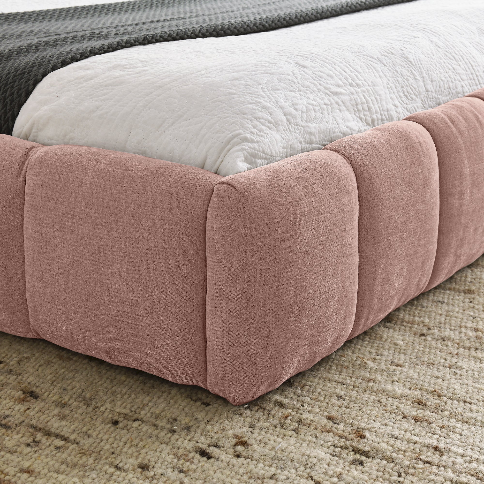Corner detail of the pink chenille channel-tufted side rail on the low profile queen bed #Color_Pink