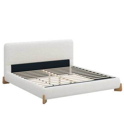 White boucle king bed frame with angled wood feet, three-quarter angle view