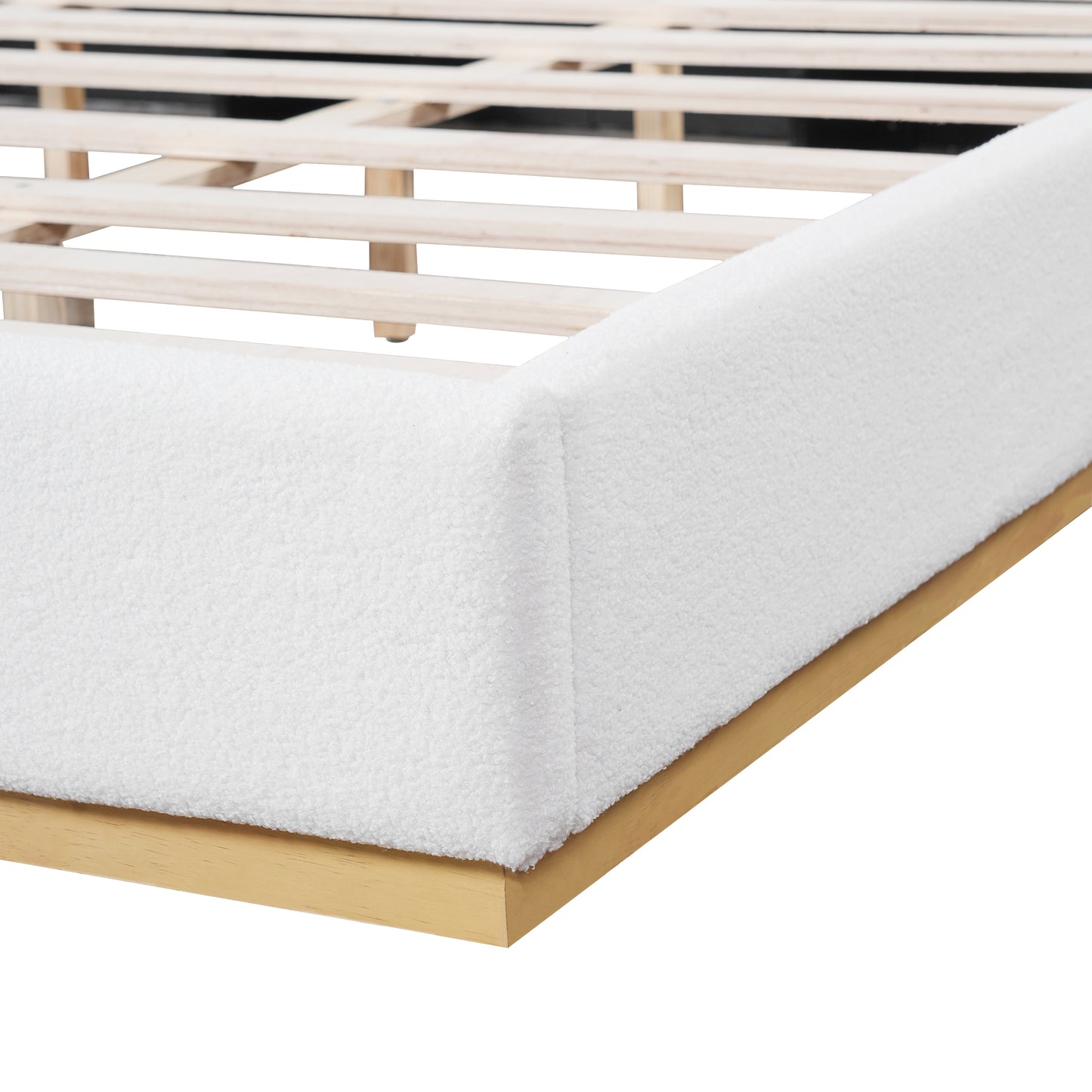 Close-up of wood slats and white bouclé side rail on king bed frame