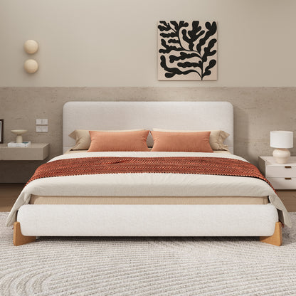 White boucle king bed in a neutral bedroom with rust and cream bedding