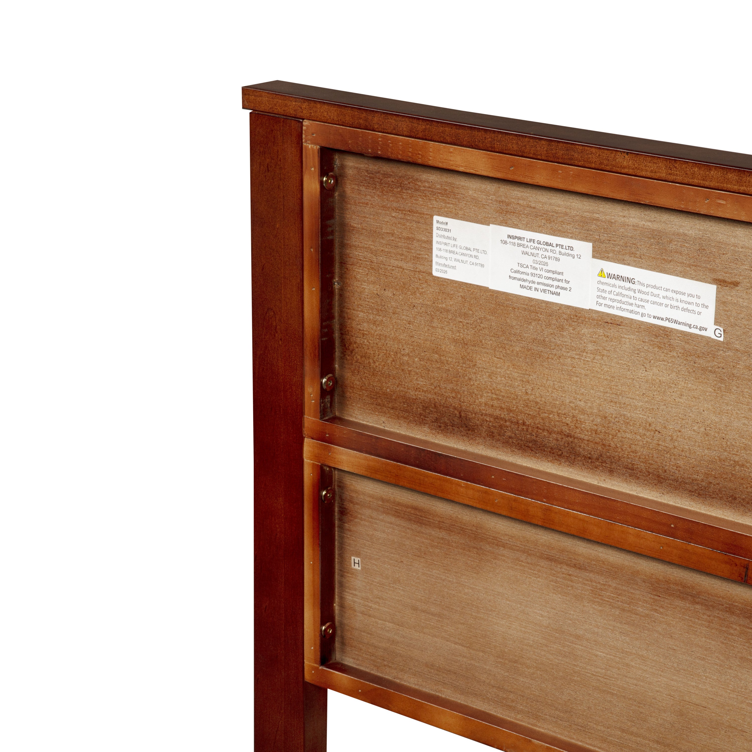 Manufacturer label and compliance sticker on back of headboard panel