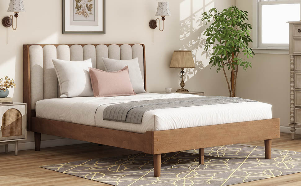 Wide view of the wheat upholstered queen bed with piano-key headboard and low wood platform frame