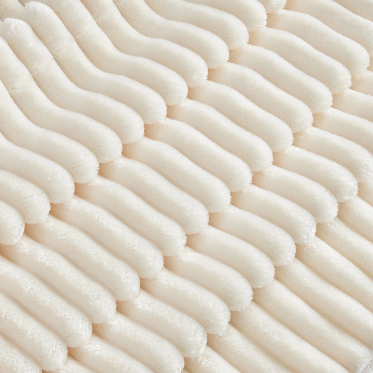 Close-up shot of fluffy cream corduroy sectional highlighting the soft ribbed texture and plush fabric detail.