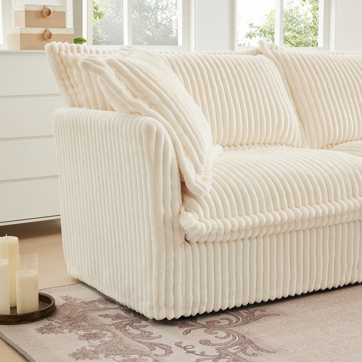 Close-up of armrest on fluffy cream corduroy sectional, highlighting plush padding, ribbed texture, and cozy design finish.