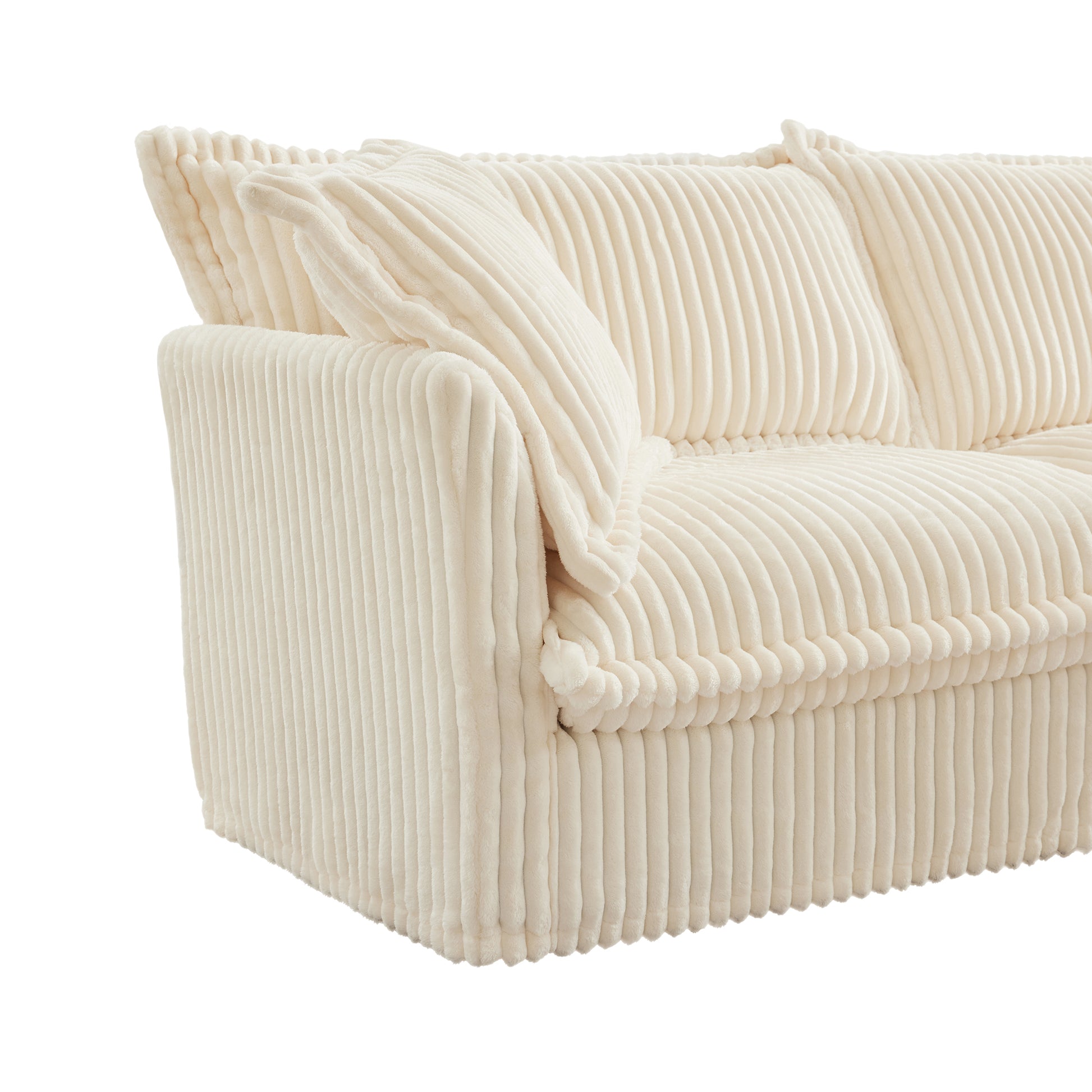 End of fluffy cream corduroy sectional highlighting plush armrest, overstuffed pillow, and soft ribbed texture for a cozy, warm finish.