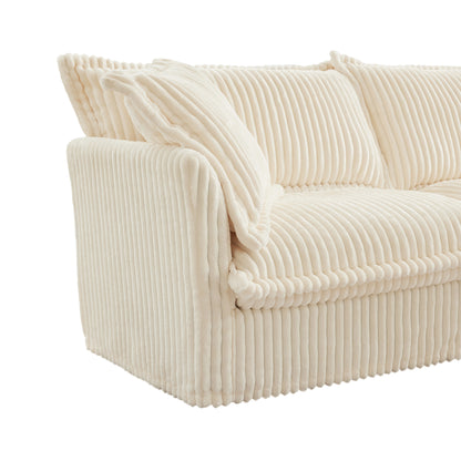 End of fluffy cream corduroy sectional highlighting plush armrest, overstuffed pillow, and soft ribbed texture for a cozy, warm finish.