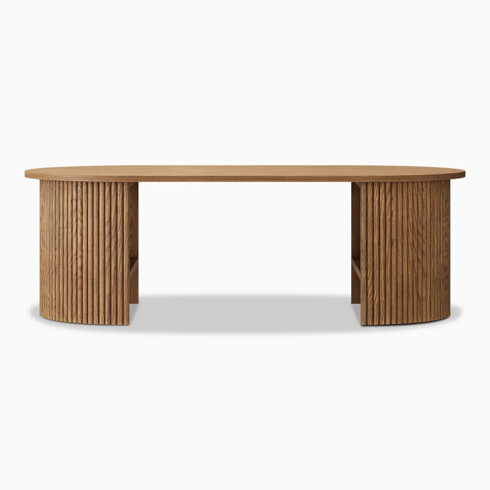 Frontal view of a Mid Century Modern Oval Coffee Table with stunning fluted legs and sculptural designs. 
