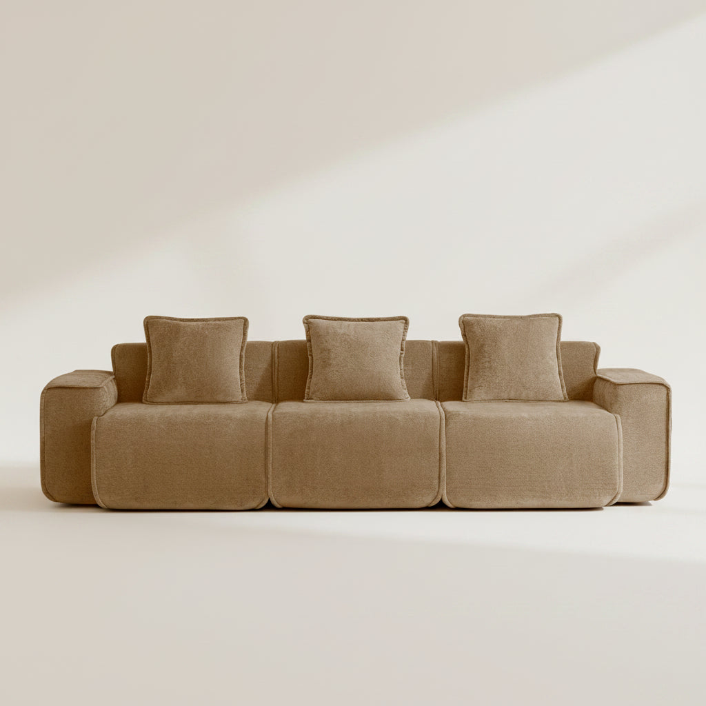 Brown sectional sofa with three cushions on a white background