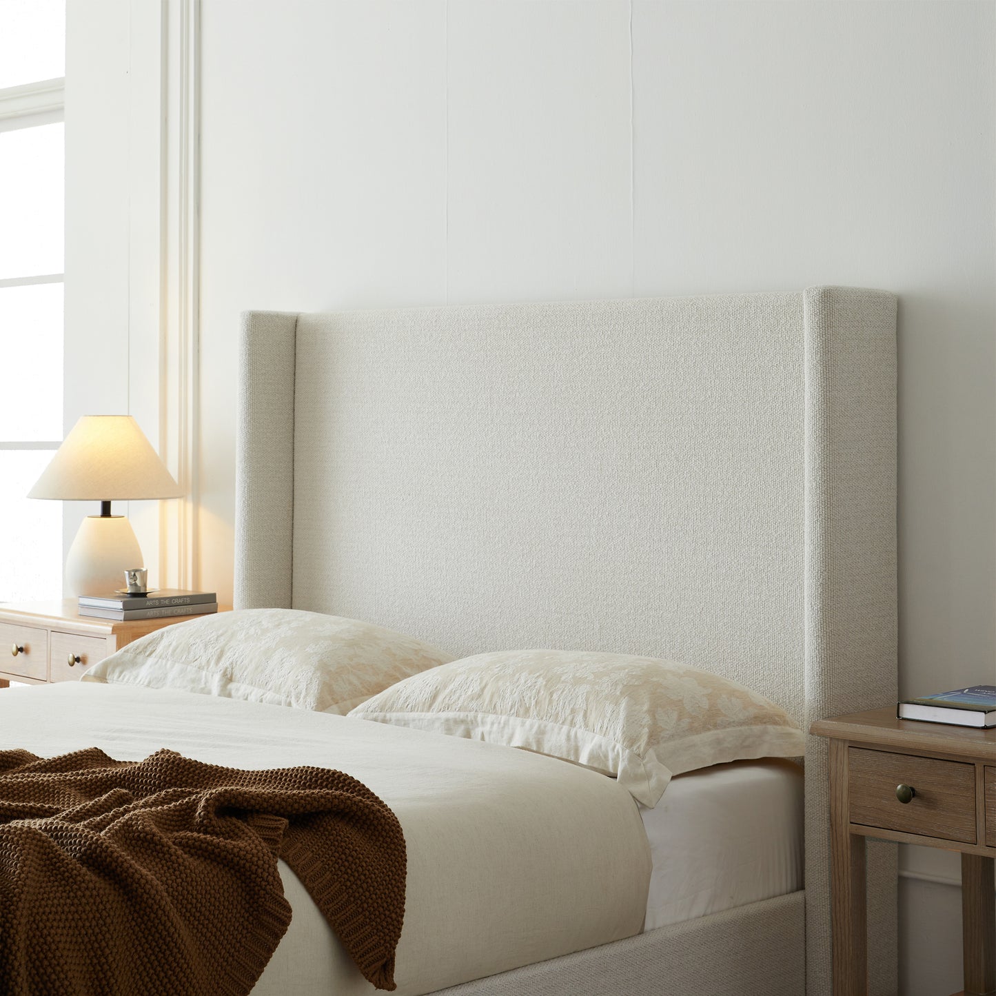 Full studio shot of cream king bed frame on white background