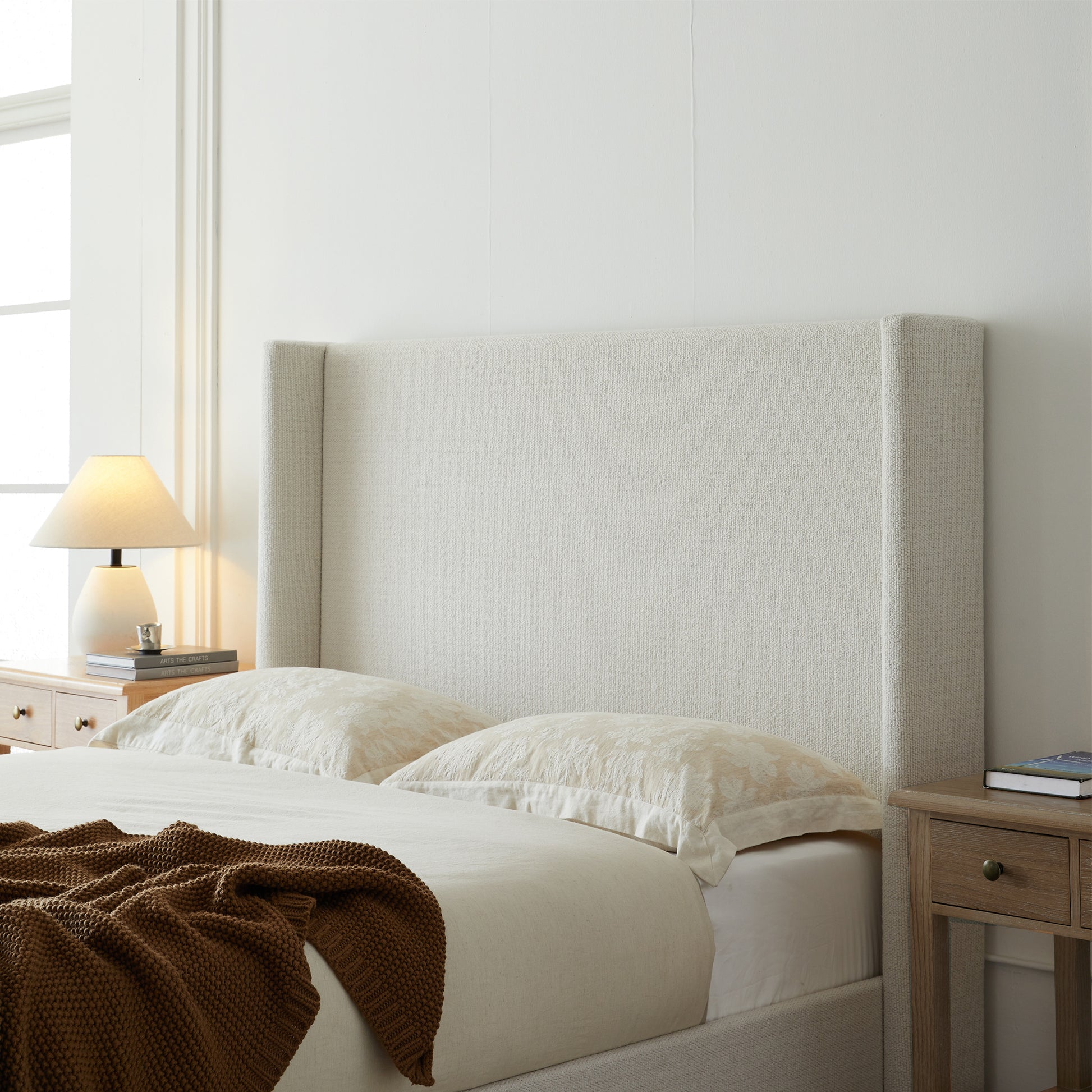 Full studio shot of cream king bed frame on white background