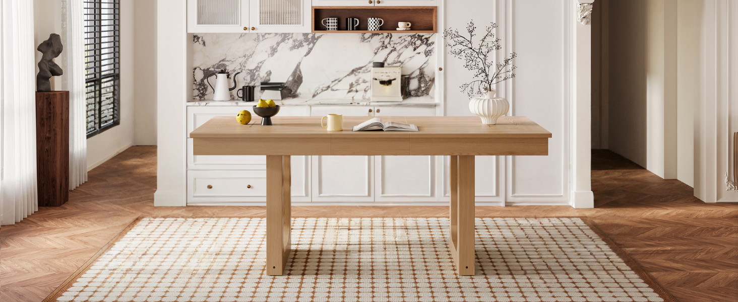 Wide front view of the natural oak extendable dining table in a marble-accented kitchen