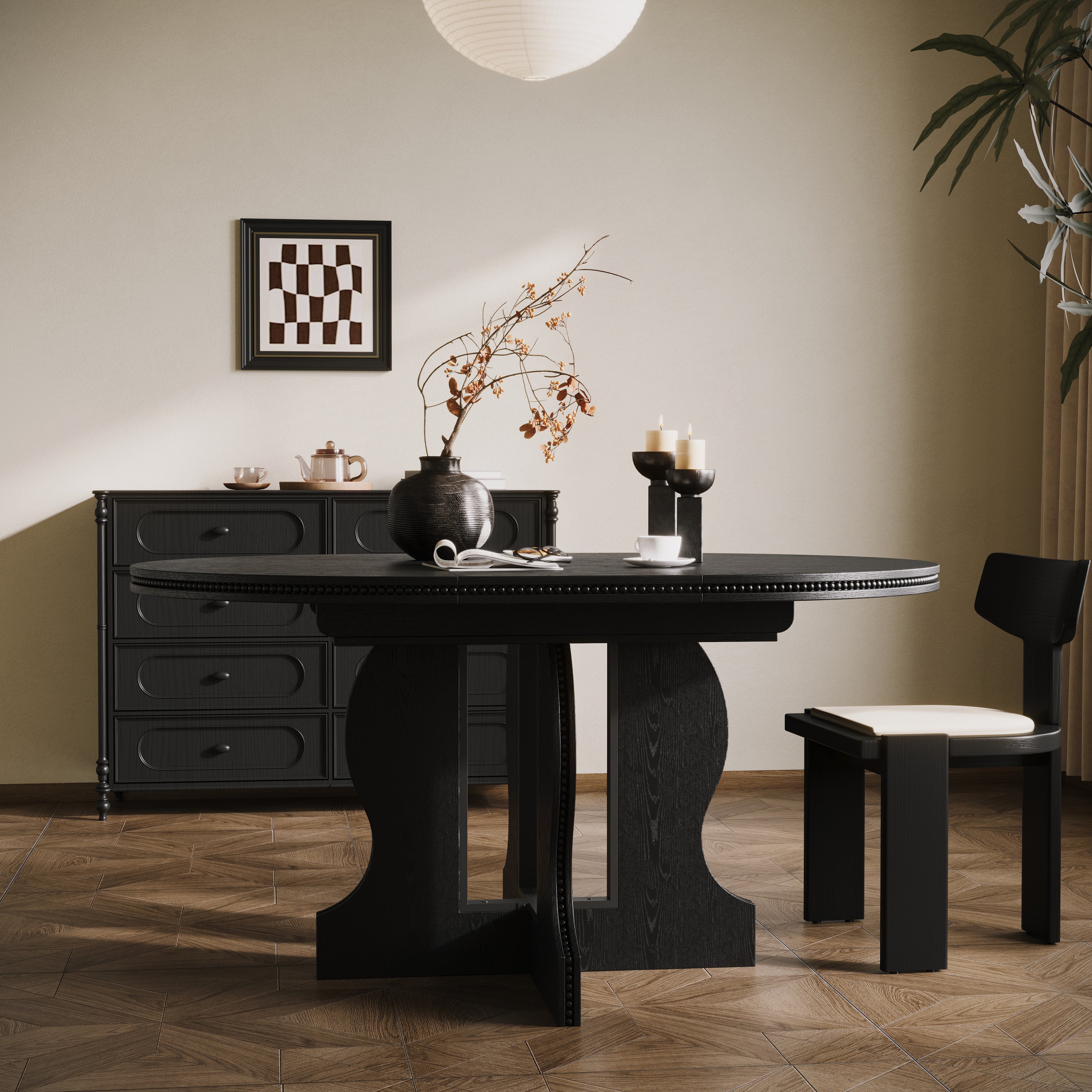 Black round pedestal dining table in a styled dining room, angled view with one chair