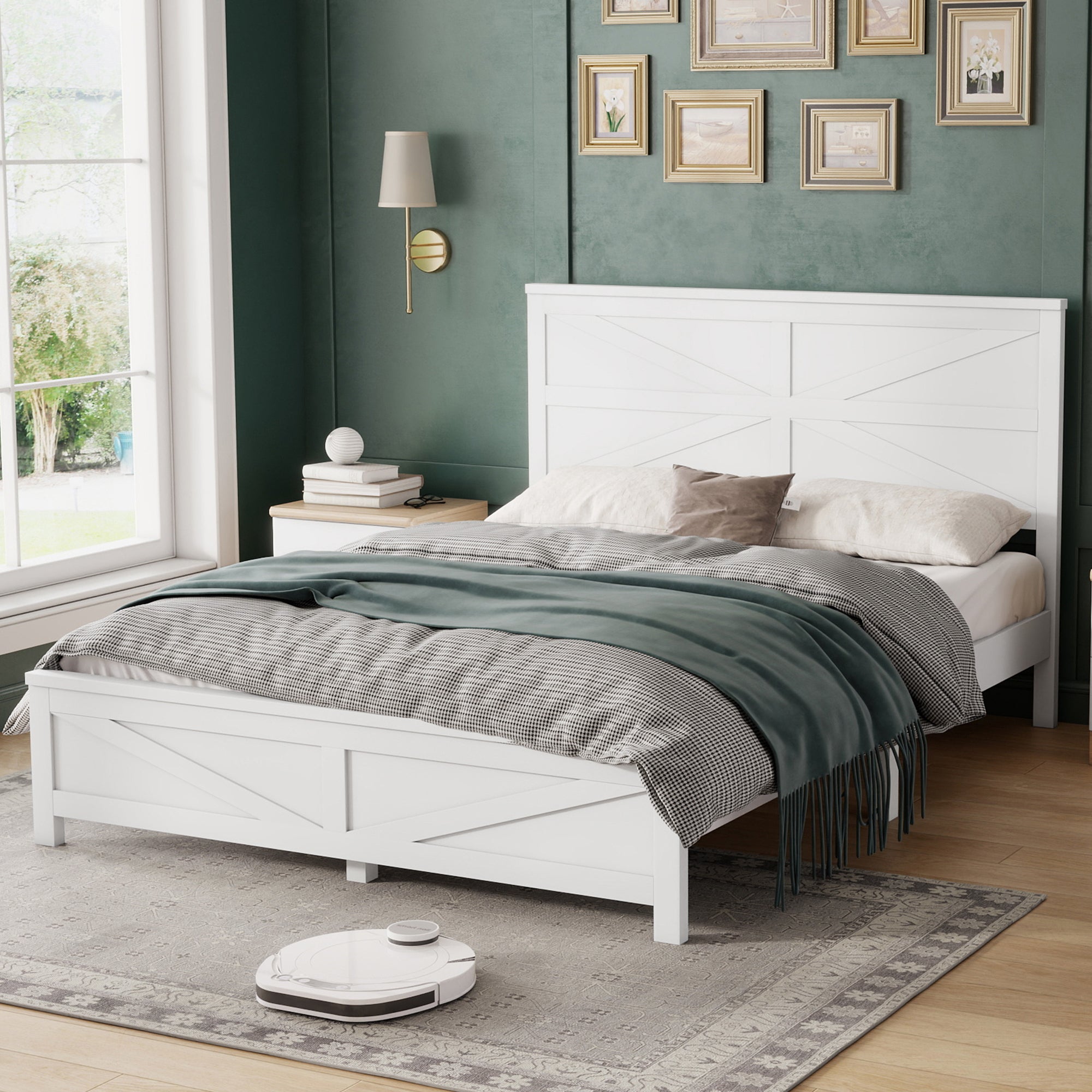 Angled view of the white pine barn door bed in a green bedroom with a window, wall sconce and layered bedding
