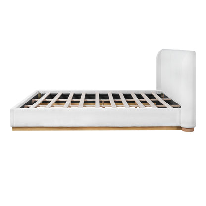 Close-up of wood base corner joint on white bouclé king bed frame