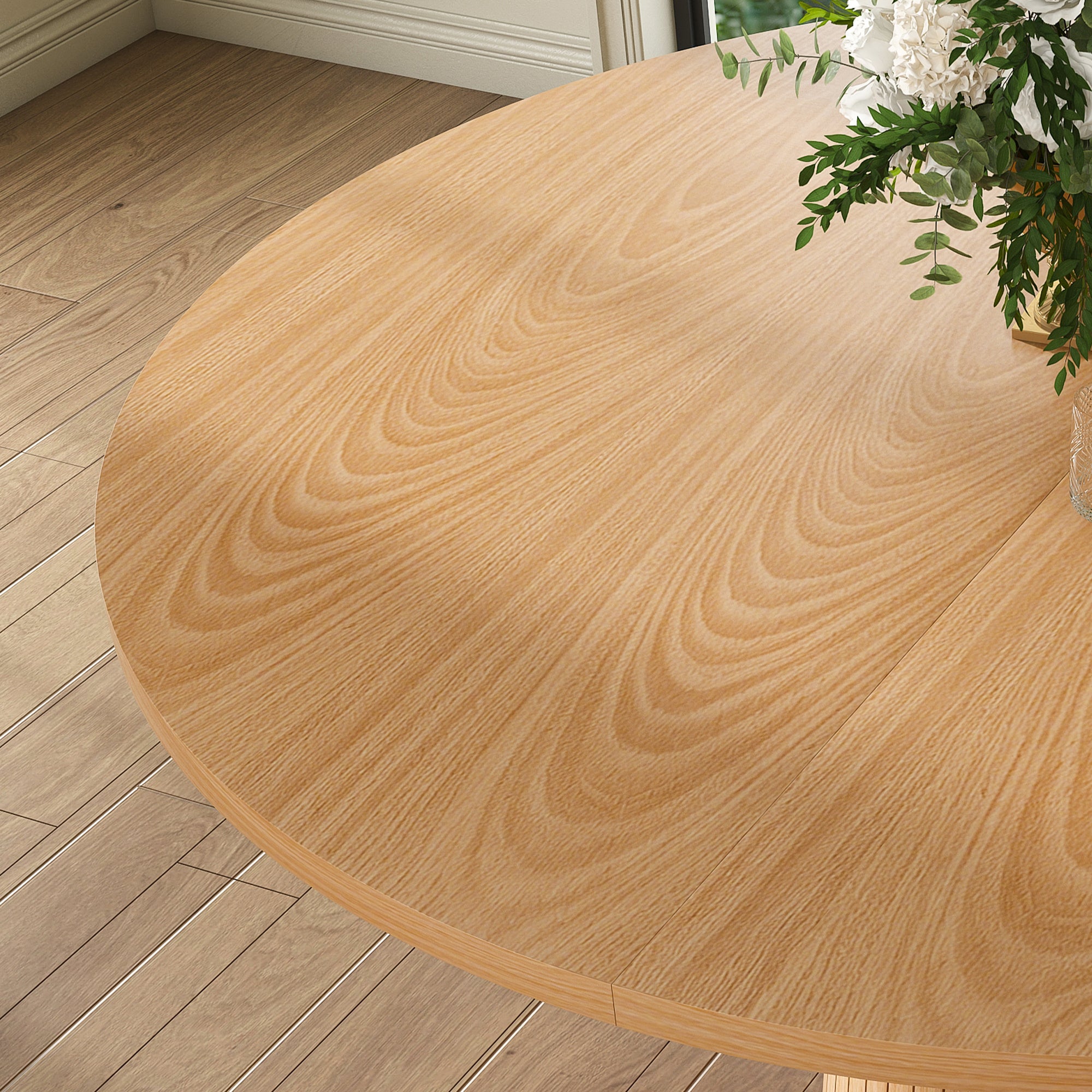 High-angle close-up of the oak tabletop wood grain with a floral arrangement in the corner