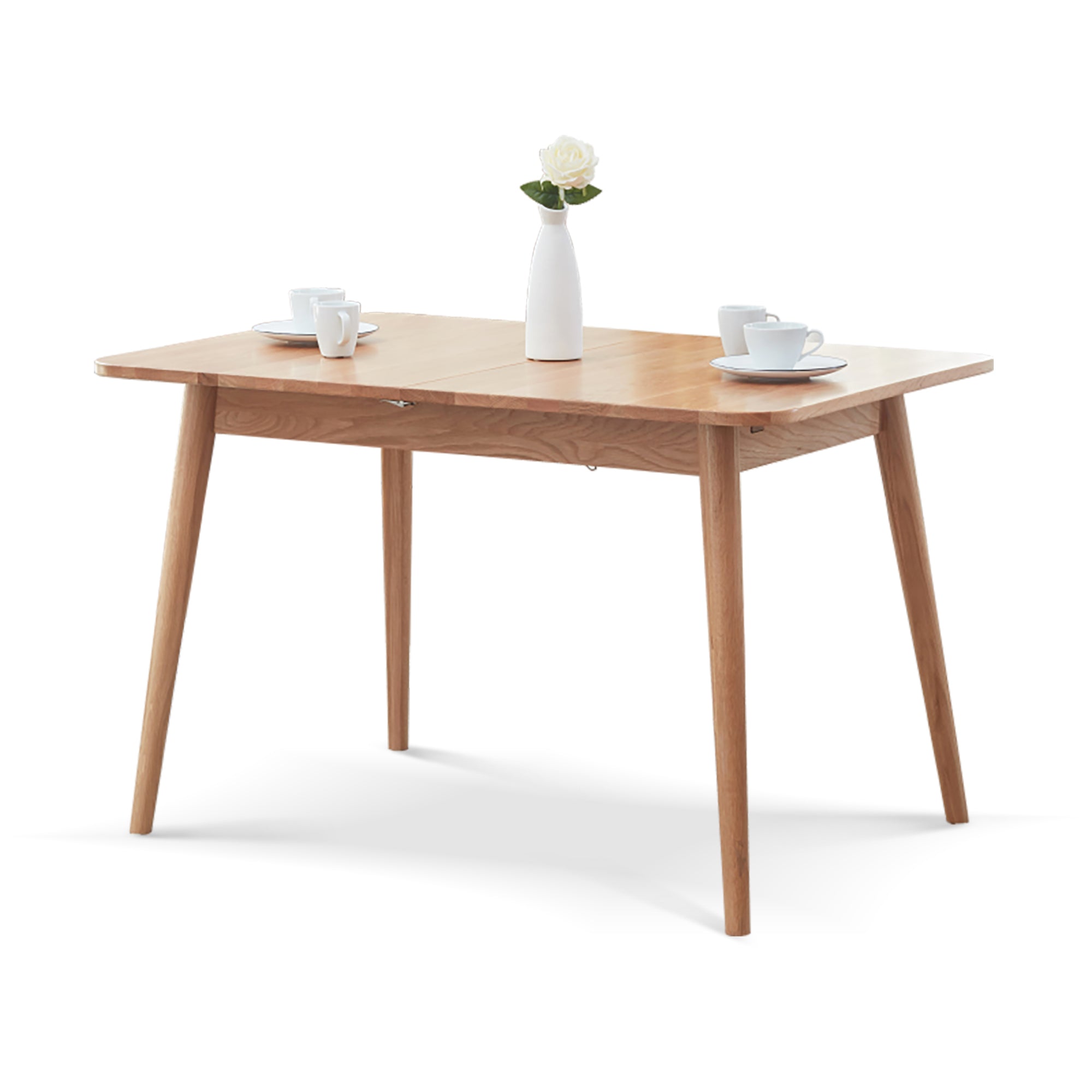 Natural oak extendable dining table with tapered legs, three-quarter view on a white background