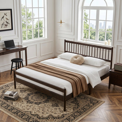 Brown pine king bed corner, desk and nightstand in background