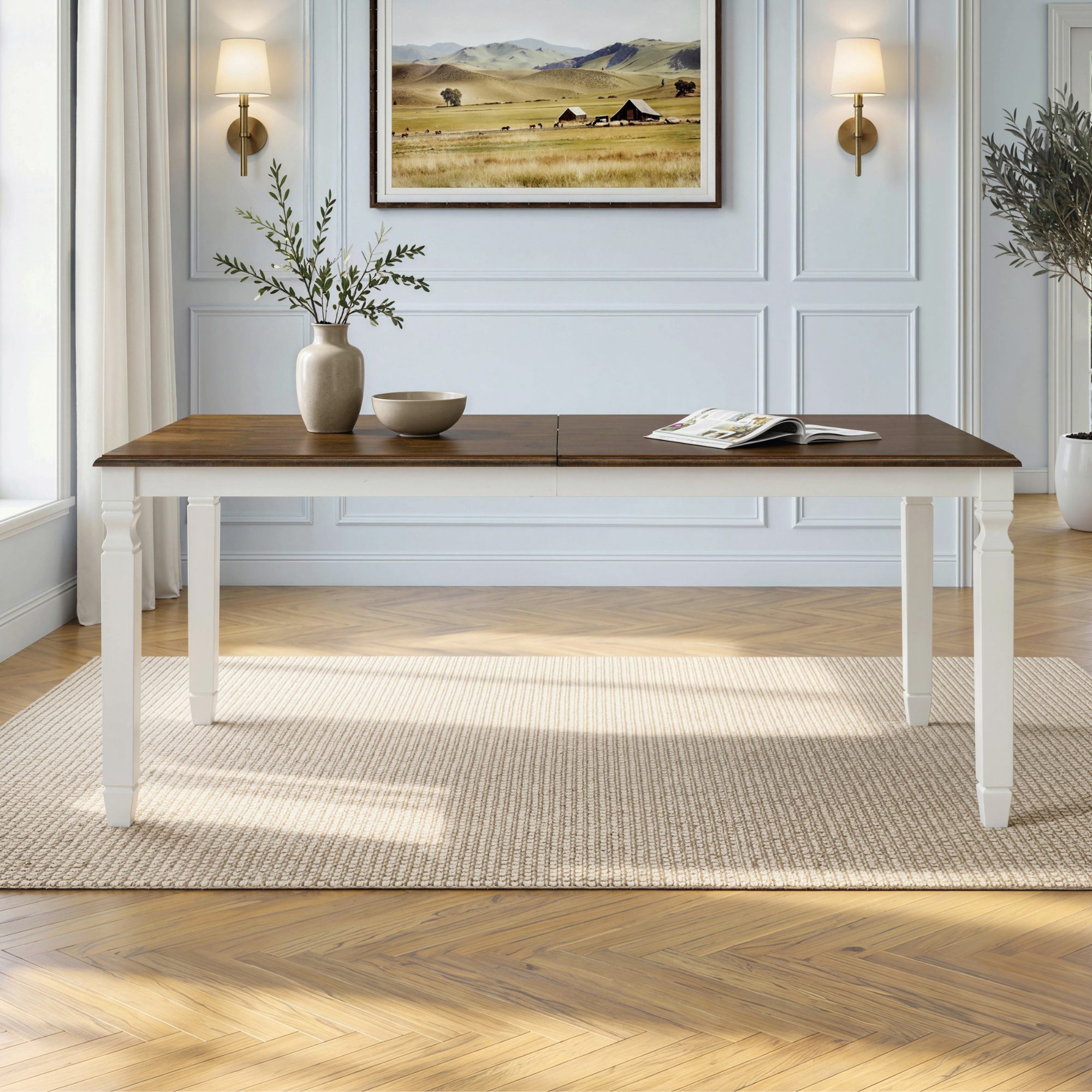 Front eye-level view of brown oak top farmhouse extendable dining table with white turned legs in a dining room
