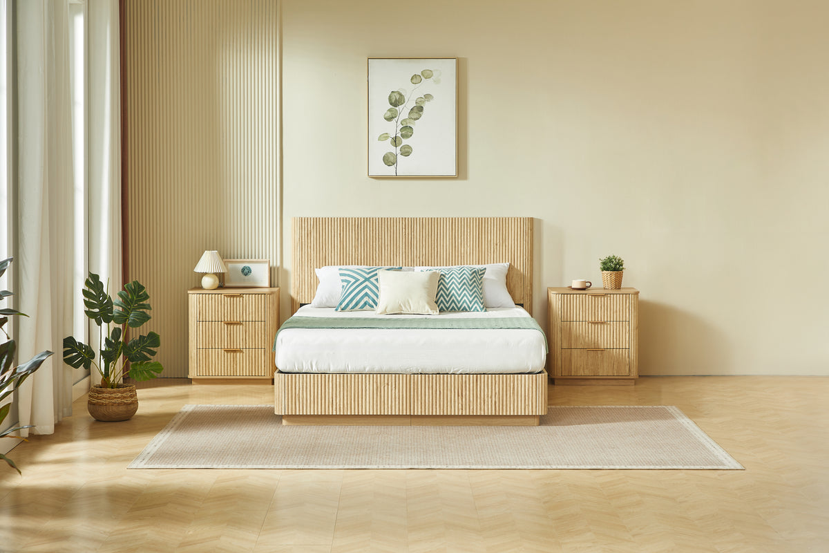 Symmetrical front view of light oak fluted queen bed styled between two matching nightstands