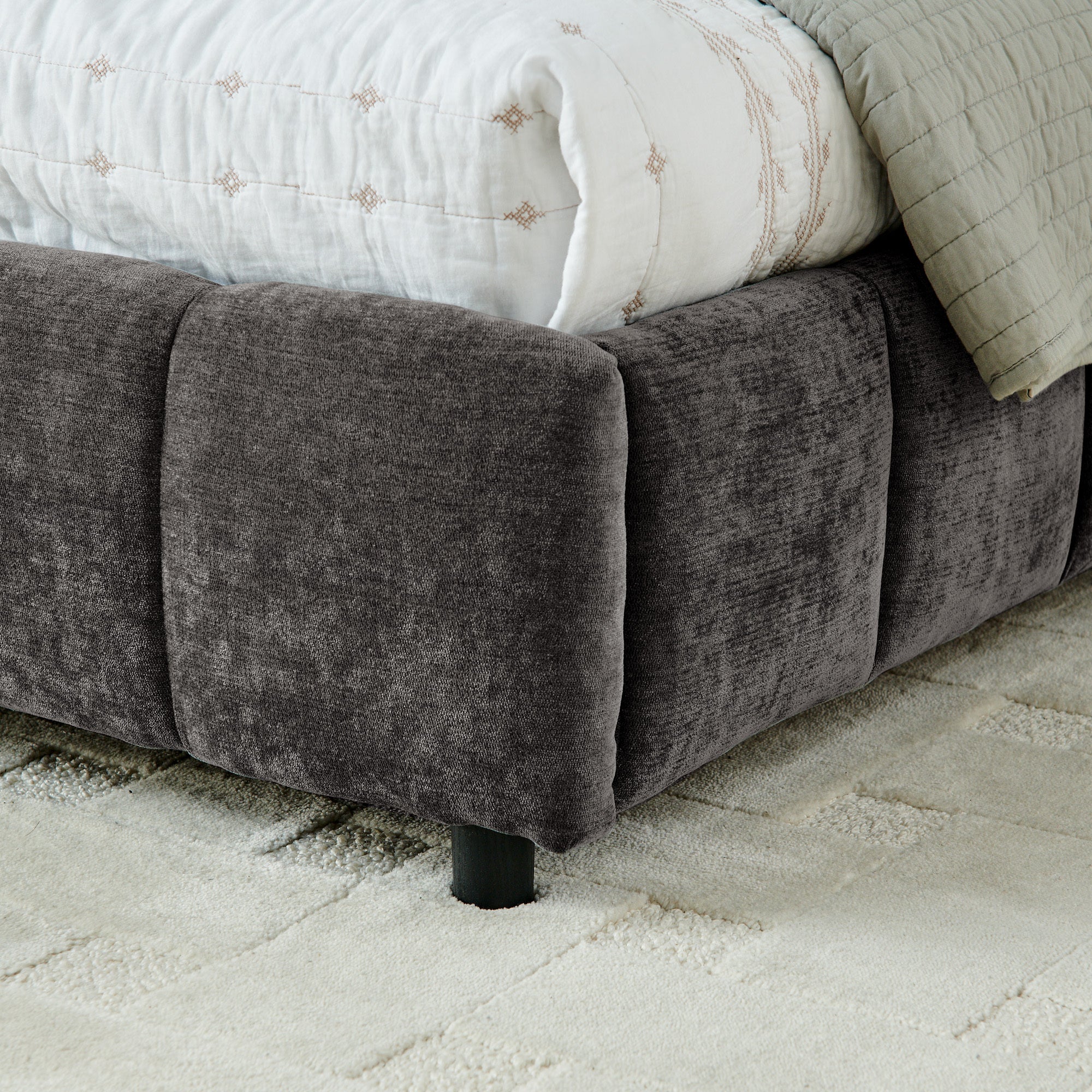 Front view of dark gray king bed frame, headboard and drawers visible