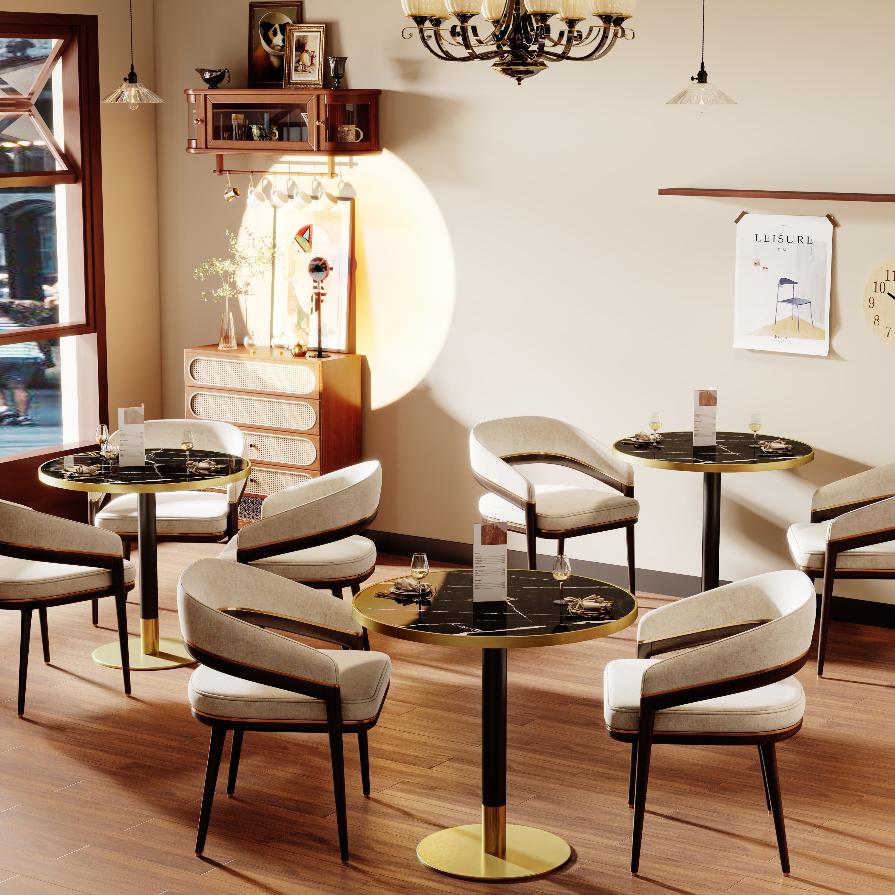 Two black and gold round dining tables styled in a warm cafe setting with cream armchairs