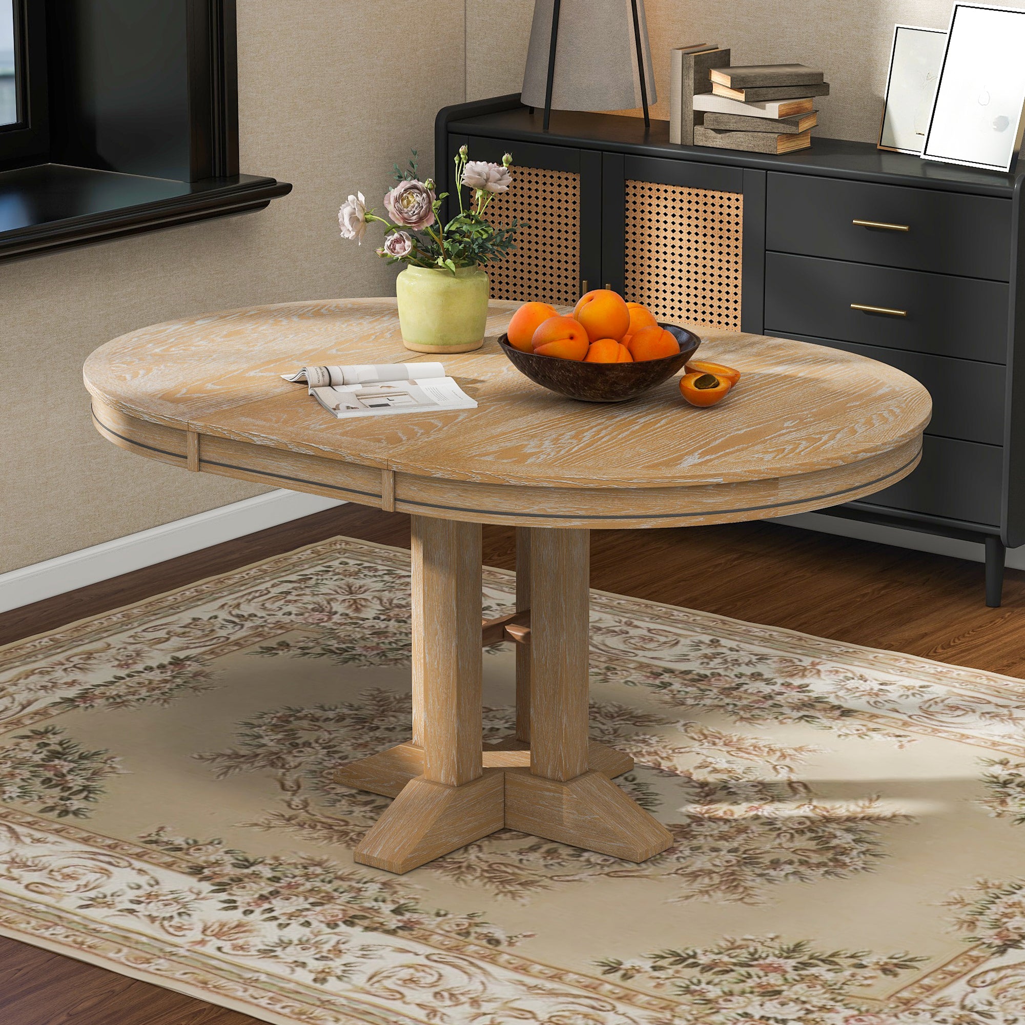 Natural oak oval-extended dining table styled with a vase and fruit bowl in a room setting