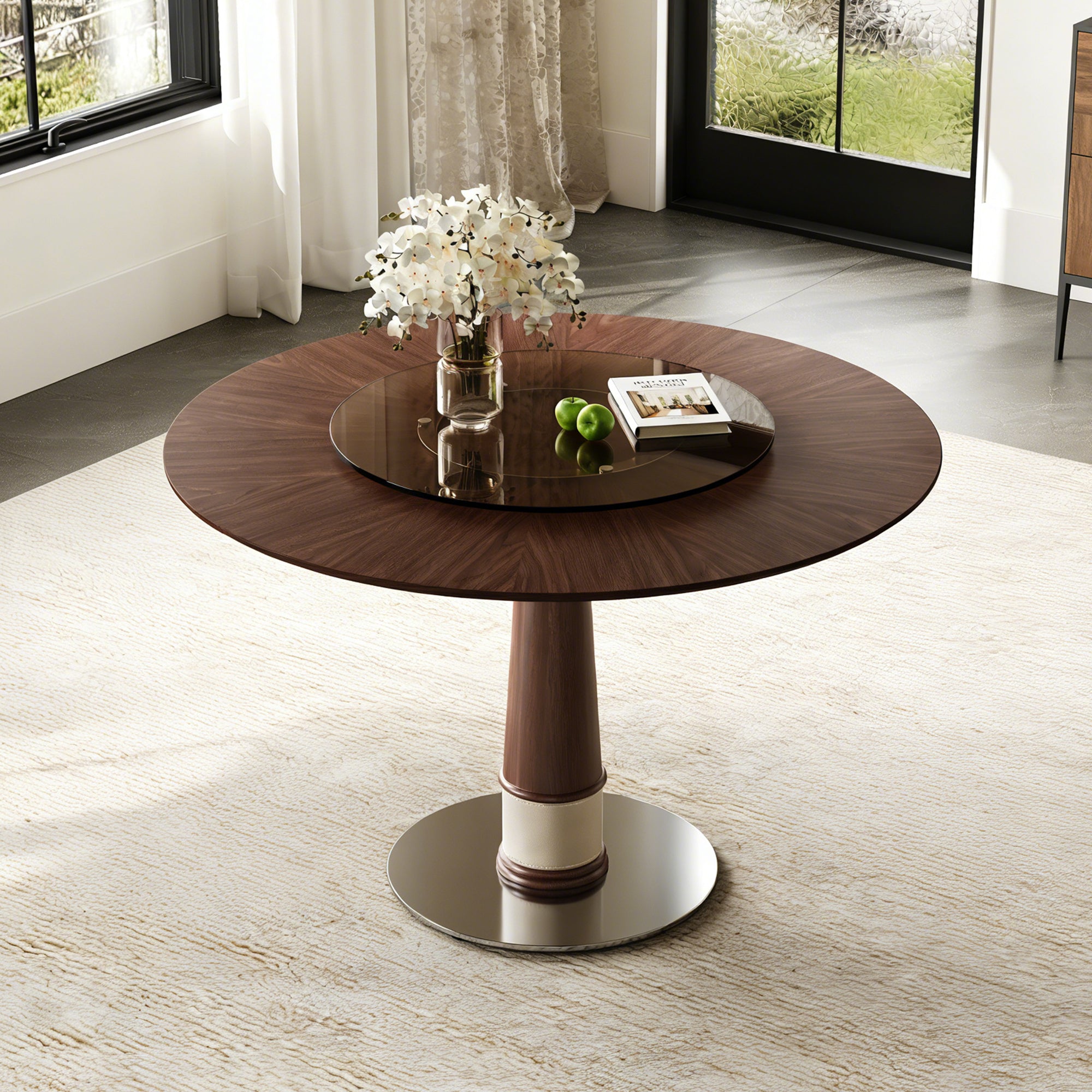 Walnut round dining table with center glass turntable in a bright styled room, angled view