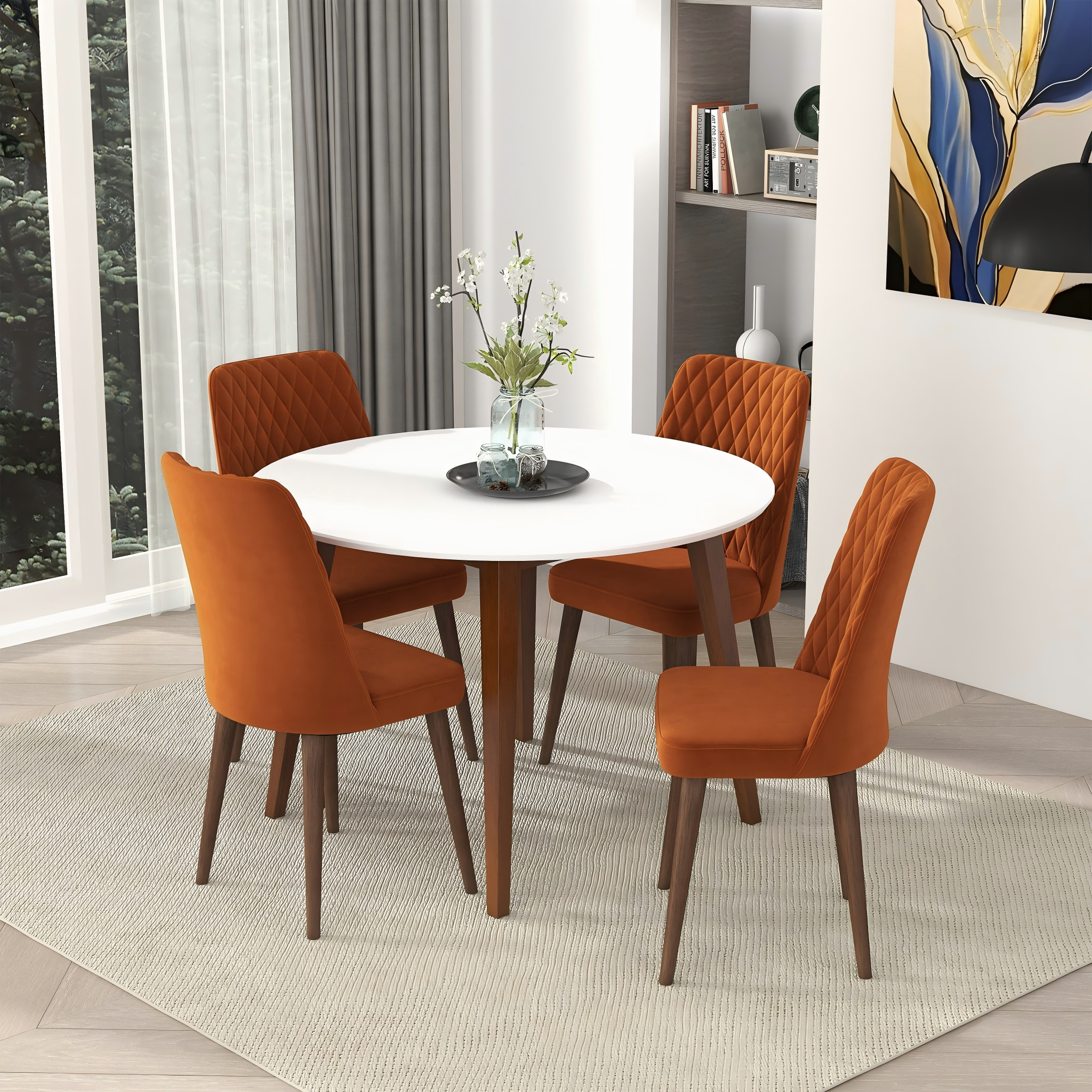 White round dining table with four orange velvet chairs in a styled dining room