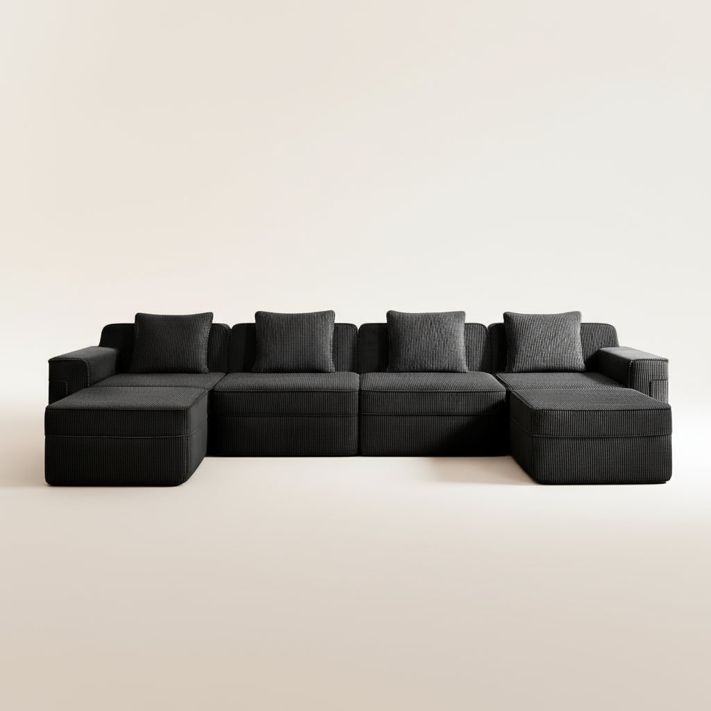 studio shot of the boneless couch in black corduroy showing the texture of the upholstery, four deep seats and two ottomans