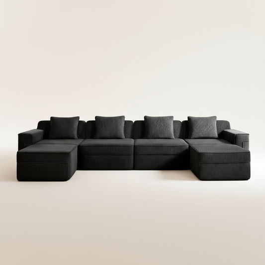studio shot of the boneless couch in black corduroy showing the texture of the upholstery, four deep seats and two ottomans