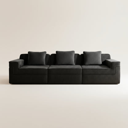 commercial photography of the black corduroy boneless couch showing rich upholstery three deep comfortable seats and pillows