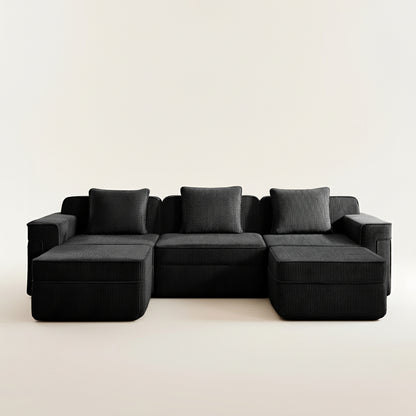 commercial studio shot of the black boneless couch showing the corduroy fabric wide armrests deep seats and comfortable seating