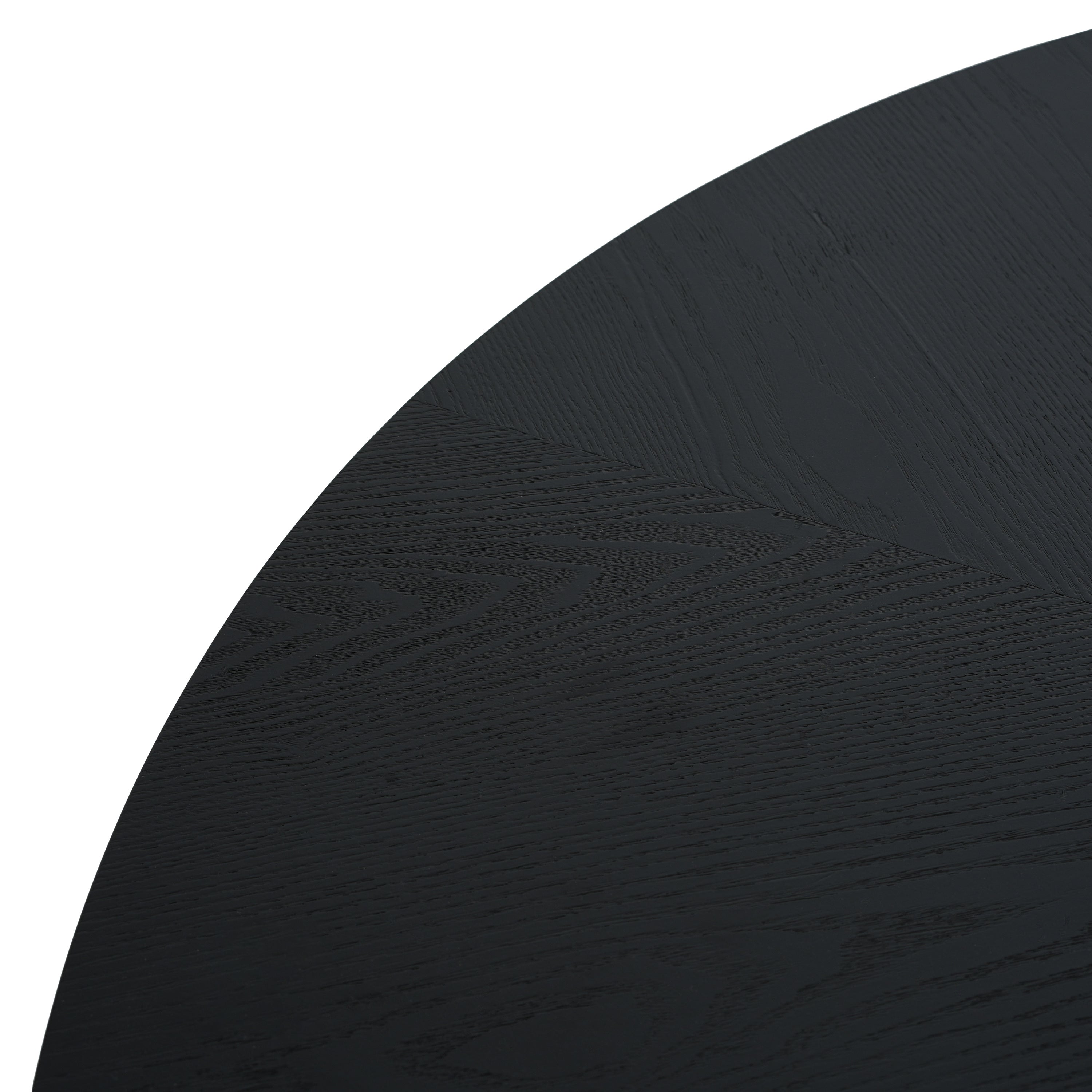 Overhead close-up of the black round tabletop edge and grain