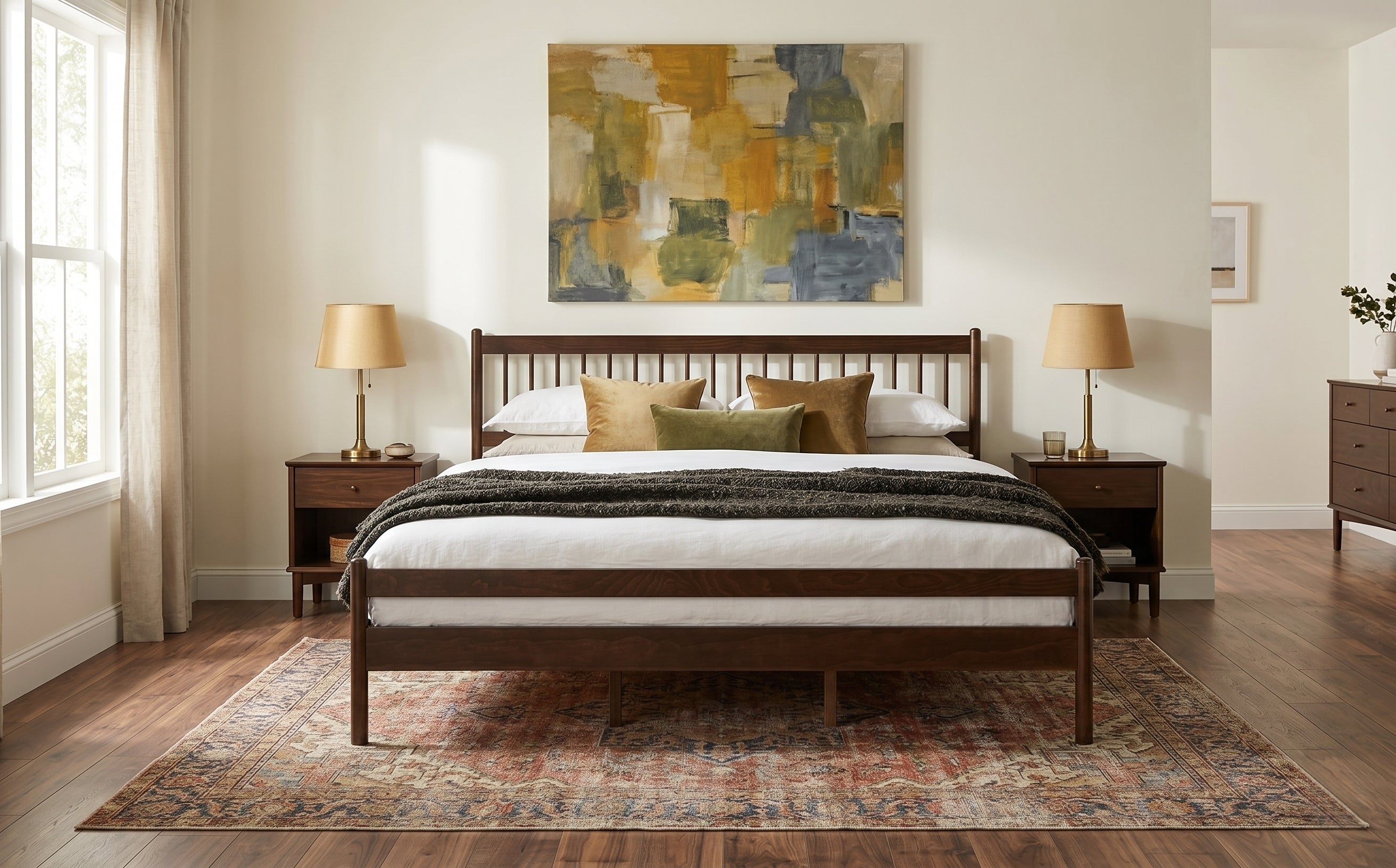 Wide bedroom shot of walnut king bed with two lamps