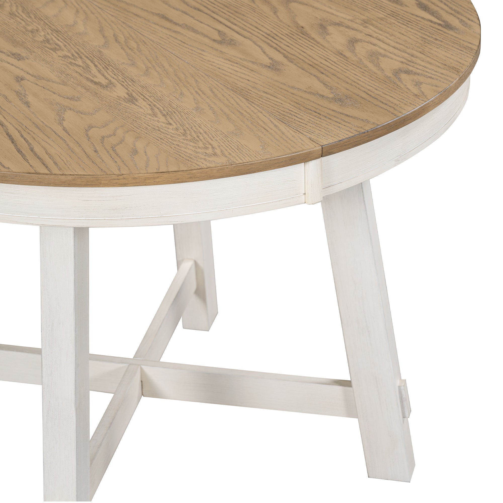 Close-up of the oak tabletop edge meeting the antique white apron and leg