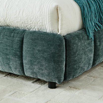 Open underbed storage drawer with pillow and folded throw inside