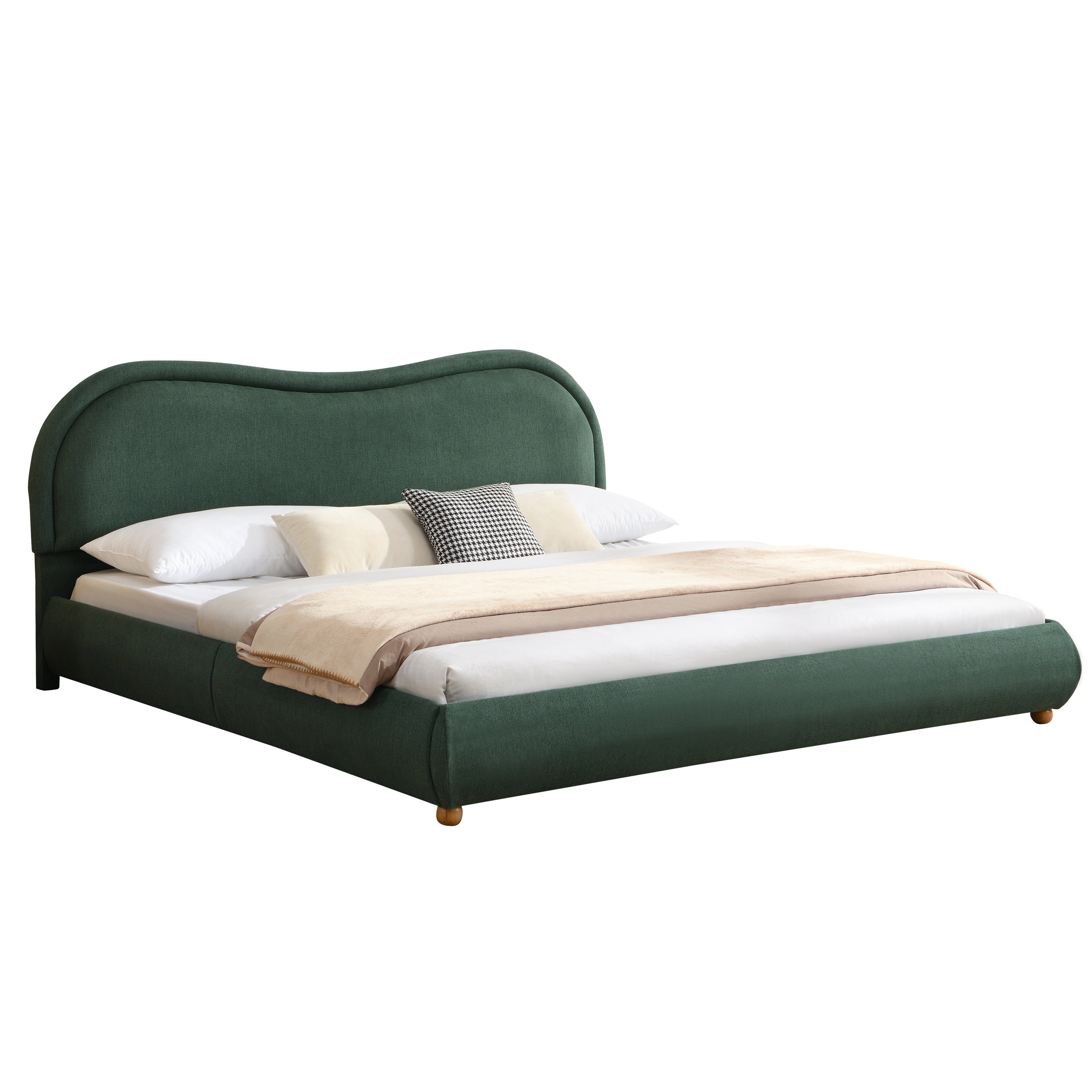 Woman reading in bed against olive green curved headboard