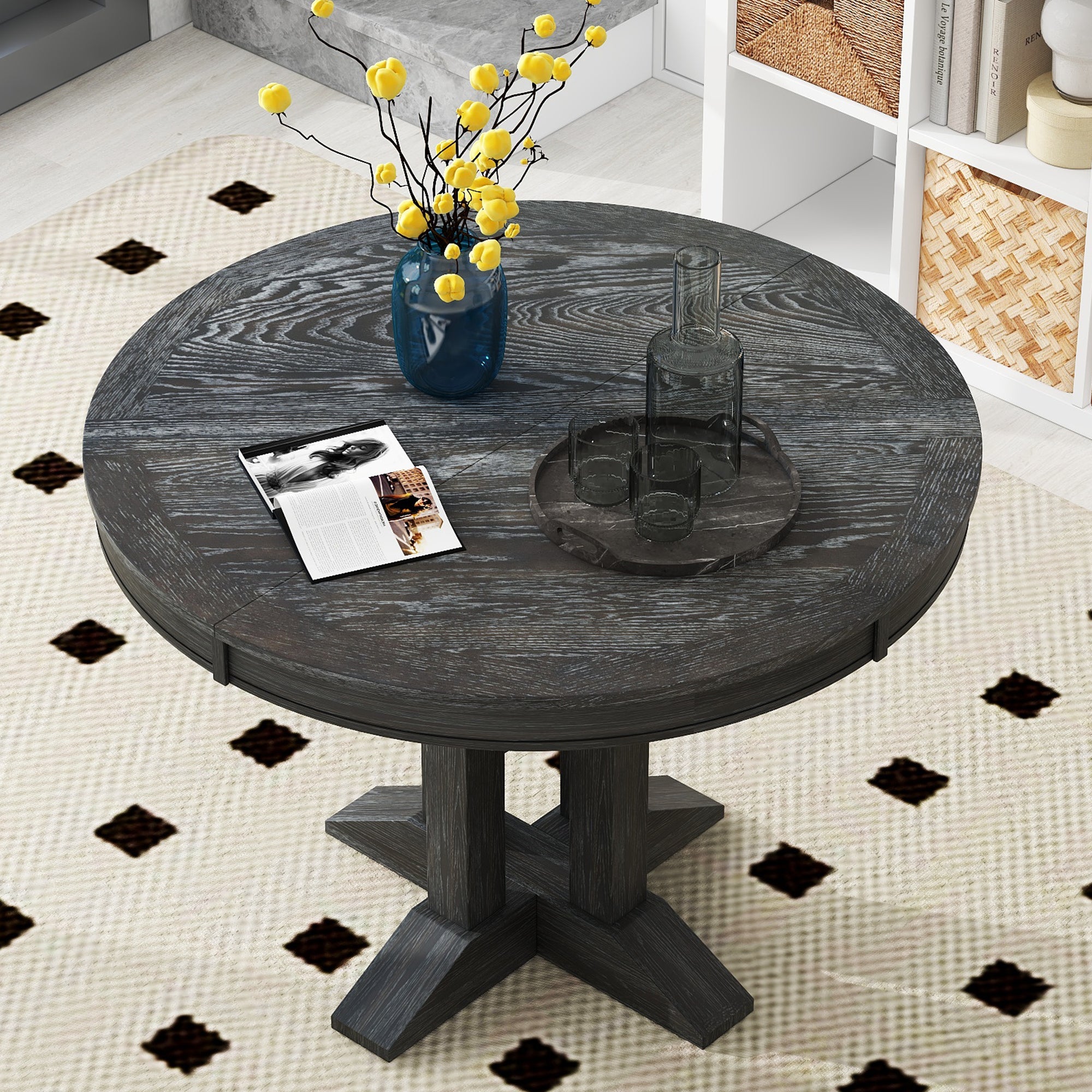 Black oval-extended dining table styled in a sunlit dining room