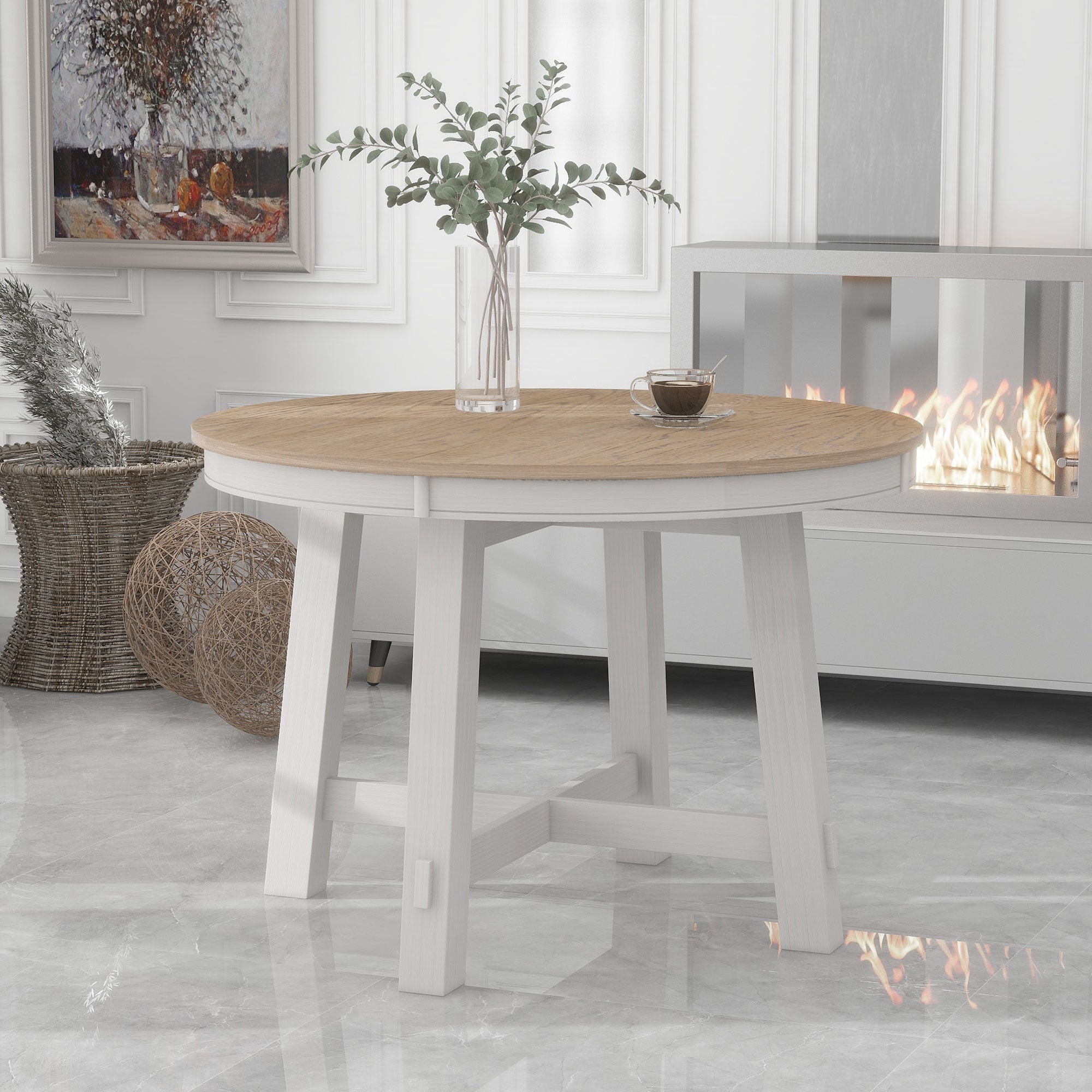 Front view of the oak-top round extendable dining table with antique white base near a fireplace