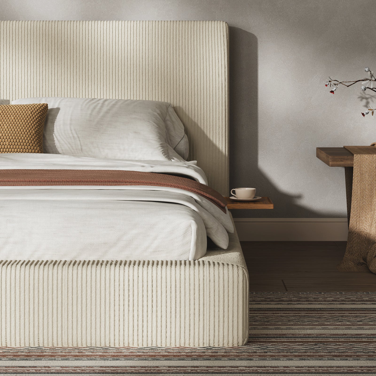 Close-up of the ribbed cream corduroy headboard and low base with a wood side shelf holding a cup