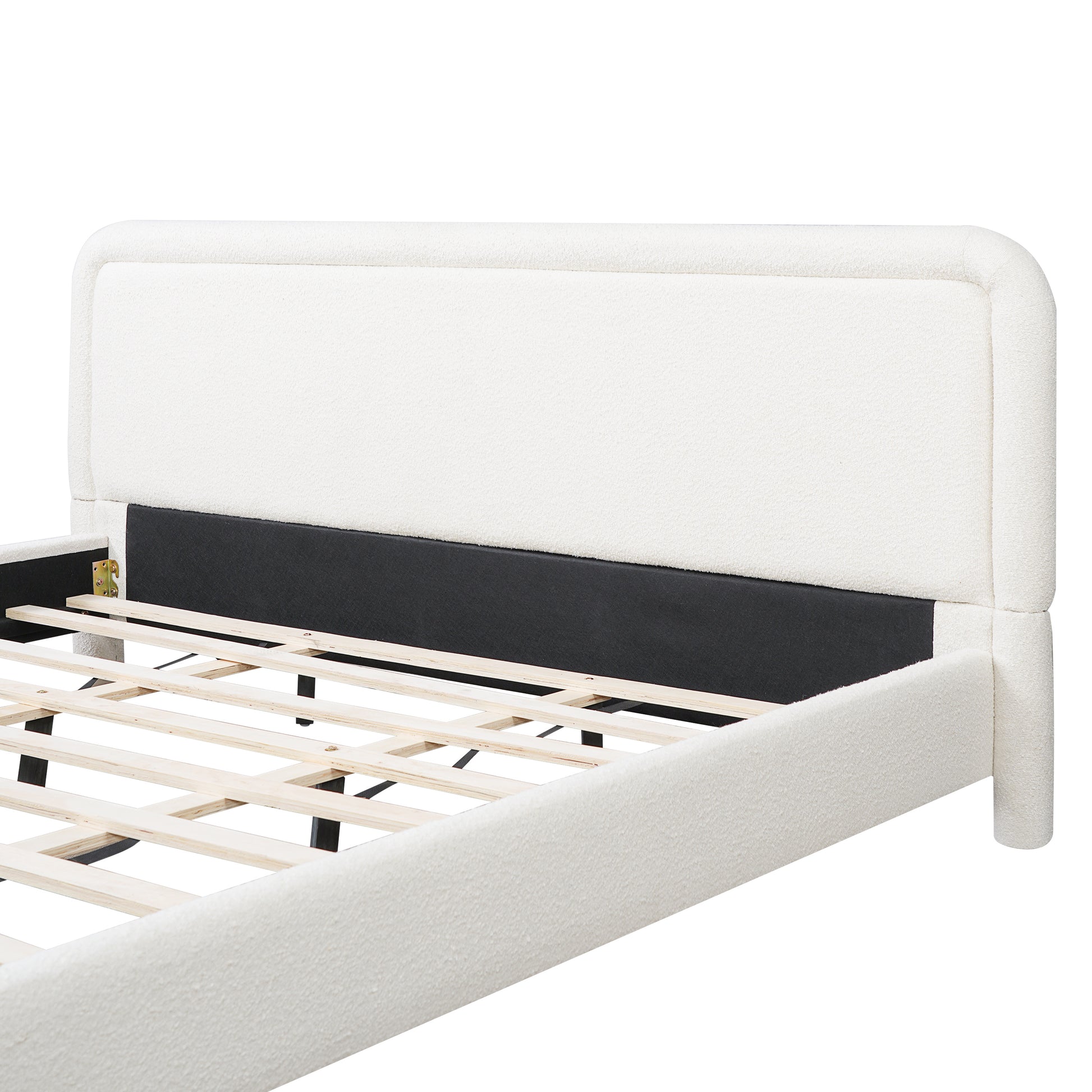 Close-up of curved headboard corner on white boucle king bed frame